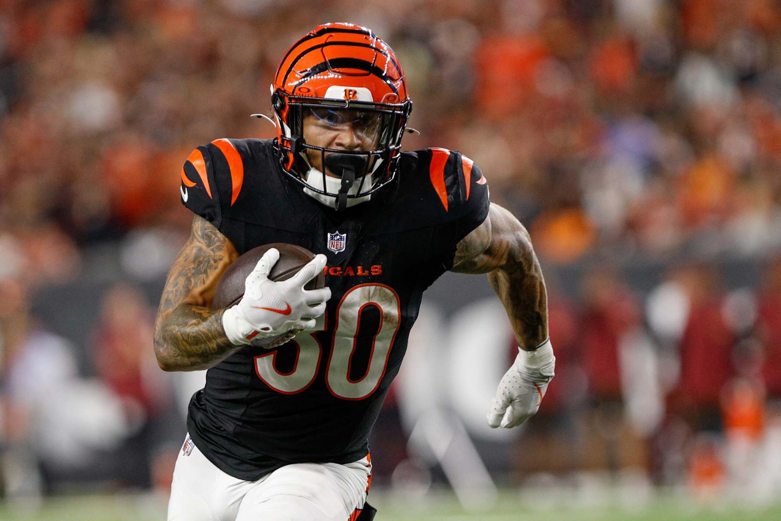 CINCINNATI, OH - SEPTEMBER 23: Cincinnati Bengals running back Chase Brown (30) carries the ball during the game against the Washington Commanders and the Cincinnati Bengals on September 23, 2024, at Paycor Stadium in Cincinnati, OH. (Photo by Ian Johnson/Icon Sportswire via Getty Images)