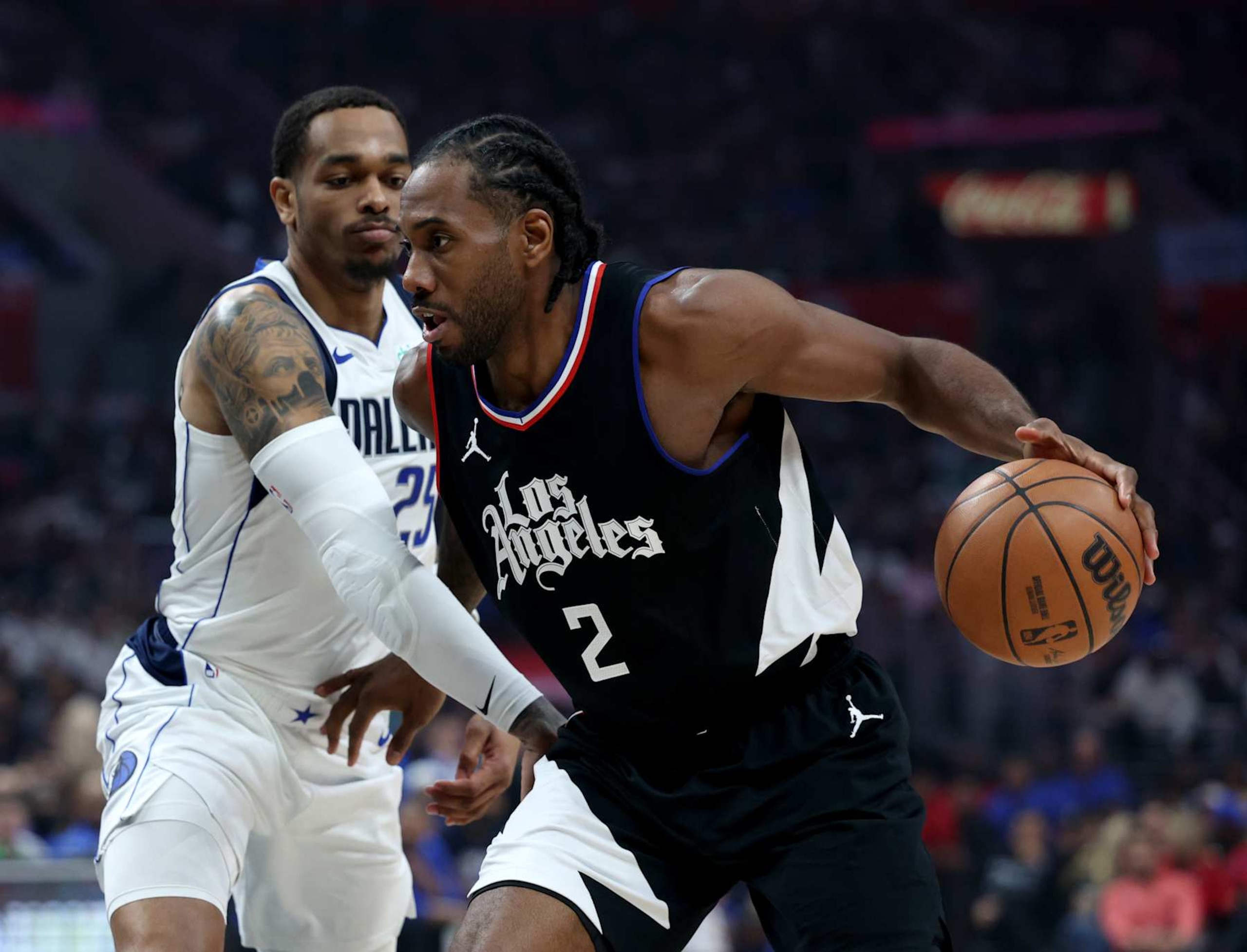 LOS ANGELES, CALIFORNIA - APRIL 23: Kawhi Leonard #2 of the LA Clippers dribbles past P.J. Washington #25 of the Dallas Mavericks during a 96-93 Mavericks win in game two of the Western Conference First Round Playoffs at Crypto.com Arena on April 23, 2024 in Los Angeles, California. User is consenting to the terms and conditions of the Getty Images License Agreement. (Photo by Harry How/Getty Images) LOS ANGELES, CALIFORNIA - APRIL 23: Kawhi Leonard #2 of the LA Clippers dribbles past P.J. Washington #25 of the Dallas Mavericks during a 96-93 Mavericks win in game two of the Western Conference First Round Playoffs at Crypto.com Arena on April 23, 2024 in Los Angeles, California. User is consenting to the terms and conditions of the Getty Images License Agreement. (Photo by Harry How/Getty Images)