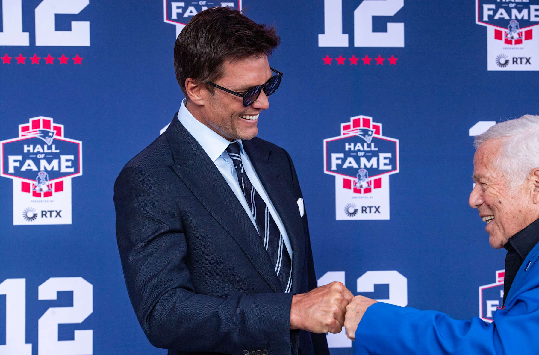 Former New England Patriots quarterback Tom Brady fists bumps CEO of the New England Patriots Robert Kraft (R) as they arrive for Brady's 2024 Hall of Fame induction ceremony at Gillette Stadium in Foxborough, Massachusetts, on June 12, 2024. Tom Brady is the 35th person to be inducted into the Patriots Hall of Fame. (Photo by Joseph Prezioso / AFP) (Photo by JOSEPH PREZIOSO/AFP via Getty Images)