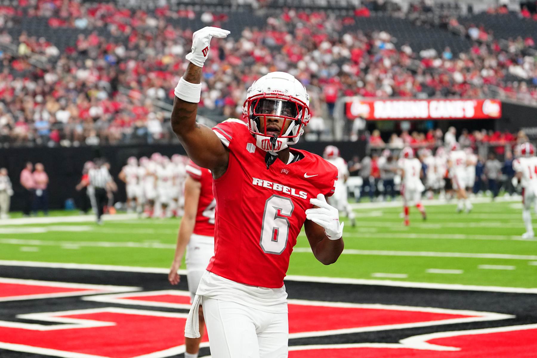 LAS VEGAS, NEVADA - SEPTEMBER 07: Hajj-Malik Williams #6 of the UNLV Rebels gestures to the crowd during the first quarter of a game against the Utah Tech Trailblazers at Allegiant Stadium on September 07, 2024 in Las Vegas, Nevada. (Photo by Louis Grasse/Getty Images)