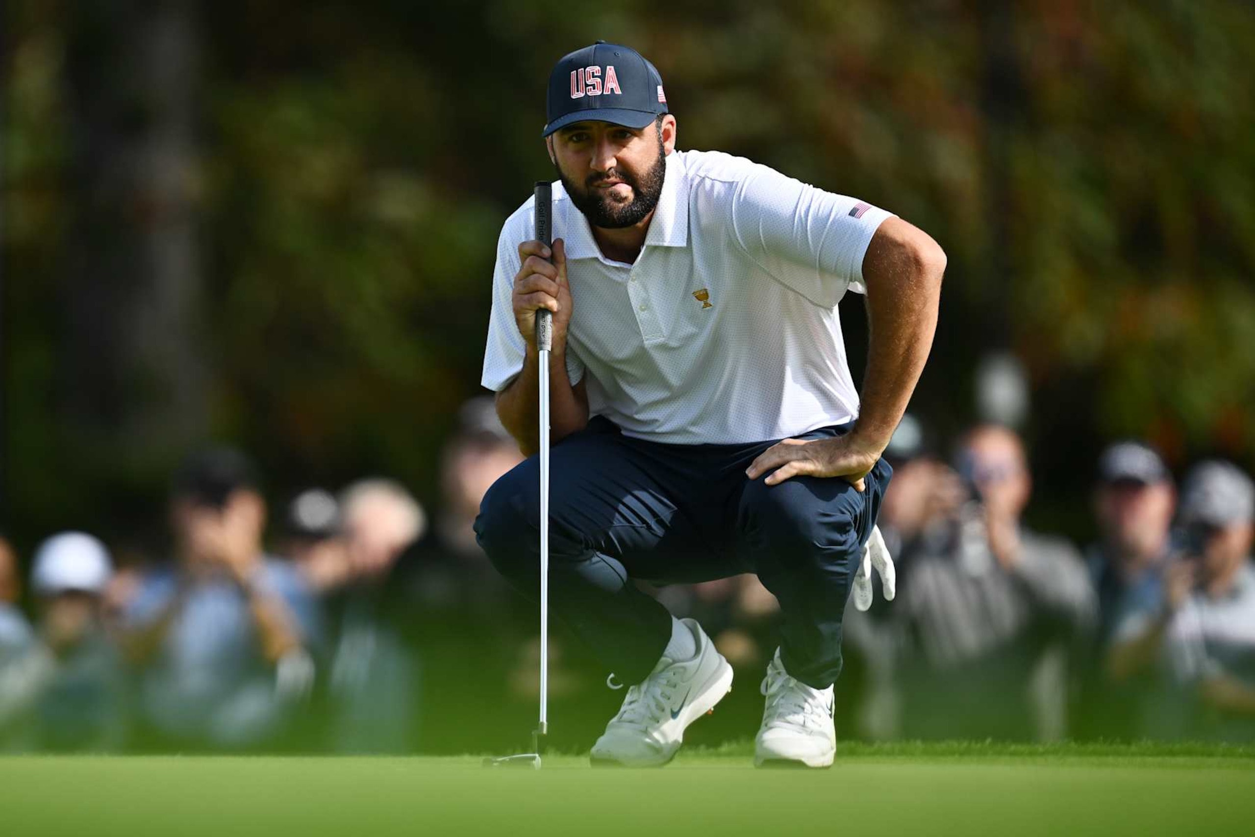 MONTREAL, QUEBEC - SEPTEMBER 26: Scottie Scheffler of the U.S. Team lines up a putt on the fourth green during Thursday's Four-ball matches on day one of the 2024 Presidents Cup at The Royal Montreal Golf Club on September 26, 2024 in Montreal, Quebec, Canada. (Photo by Minas Panagiotakis/Getty Images)