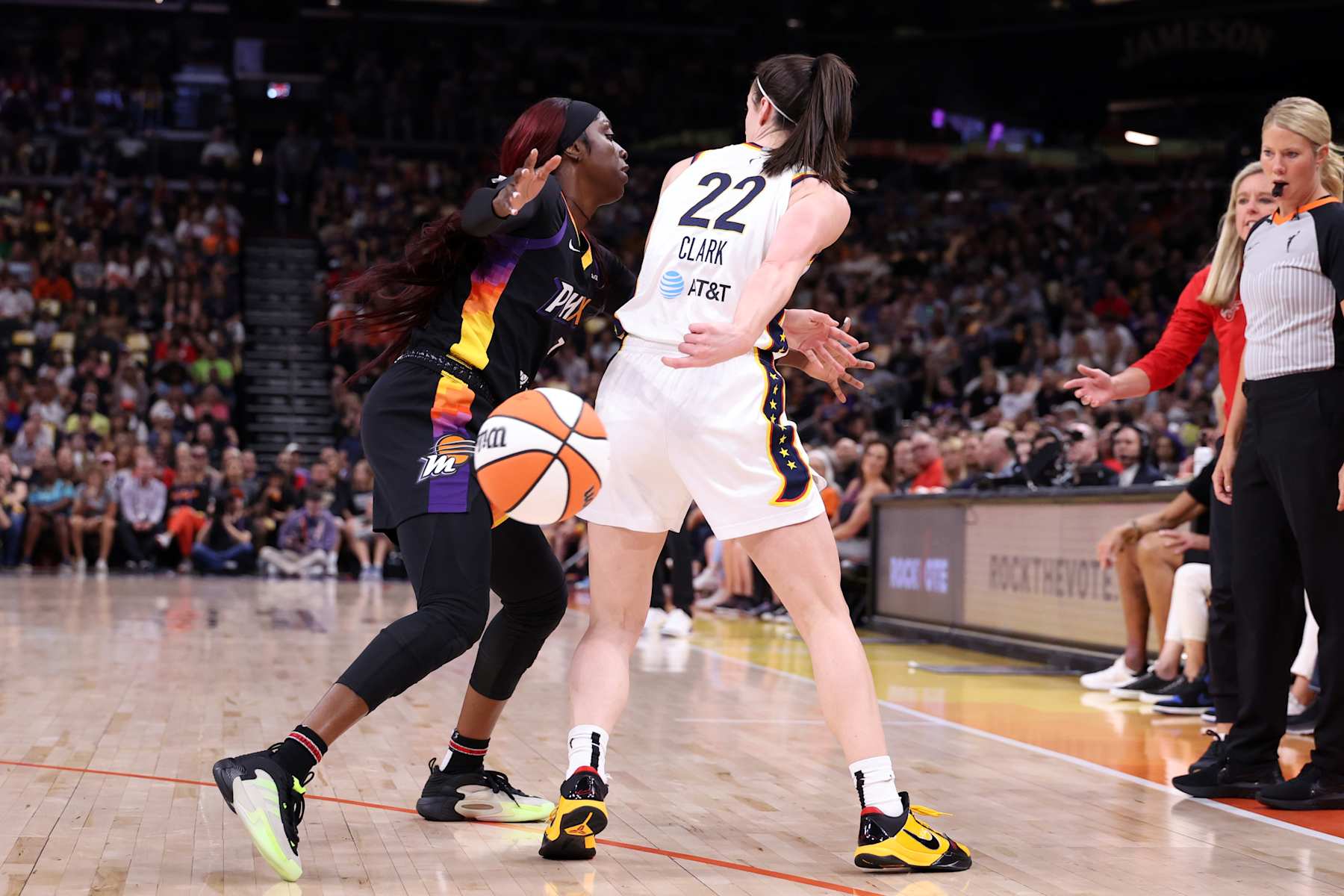 PHOENIX, ARIZONA - JUNE 30: Guard Caitlin Clark #22 of the Indiana Fever passes around guard Kahleah Copper #2 of the Phoenix Mercury during the game at Footprint Center on June 30, 2024 in Phoenix, Arizona. The Fever defeated the Mercury 88-82. NOTE TO USER: User expressly acknowledges and agrees that, by downloading and or using this photograph, User is consenting to the terms and conditions of the Getty Images License Agreement.  (Photo by Chris Coduto/Getty Images)