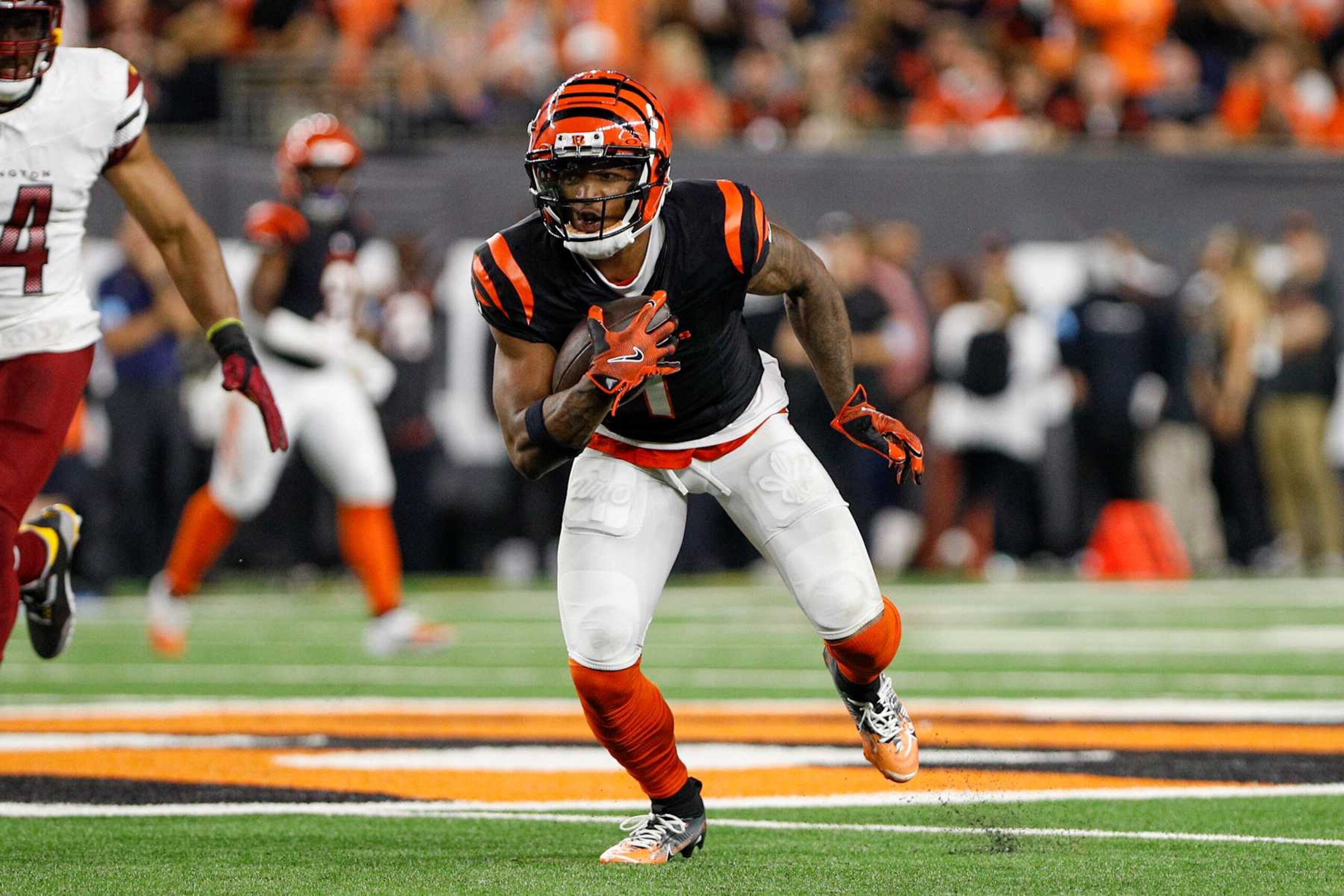 CINCINNATI, OH - SEPTEMBER 23: Cincinnati Bengals wide receiver Ja'Marr Chase (1) carries the ball during the game against the Washington Commanders and the Cincinnati Bengals on September 23, 2024, at Paycor Stadium in Cincinnati, OH. (Photo by Ian Johnson/Icon Sportswire via Getty Images)
