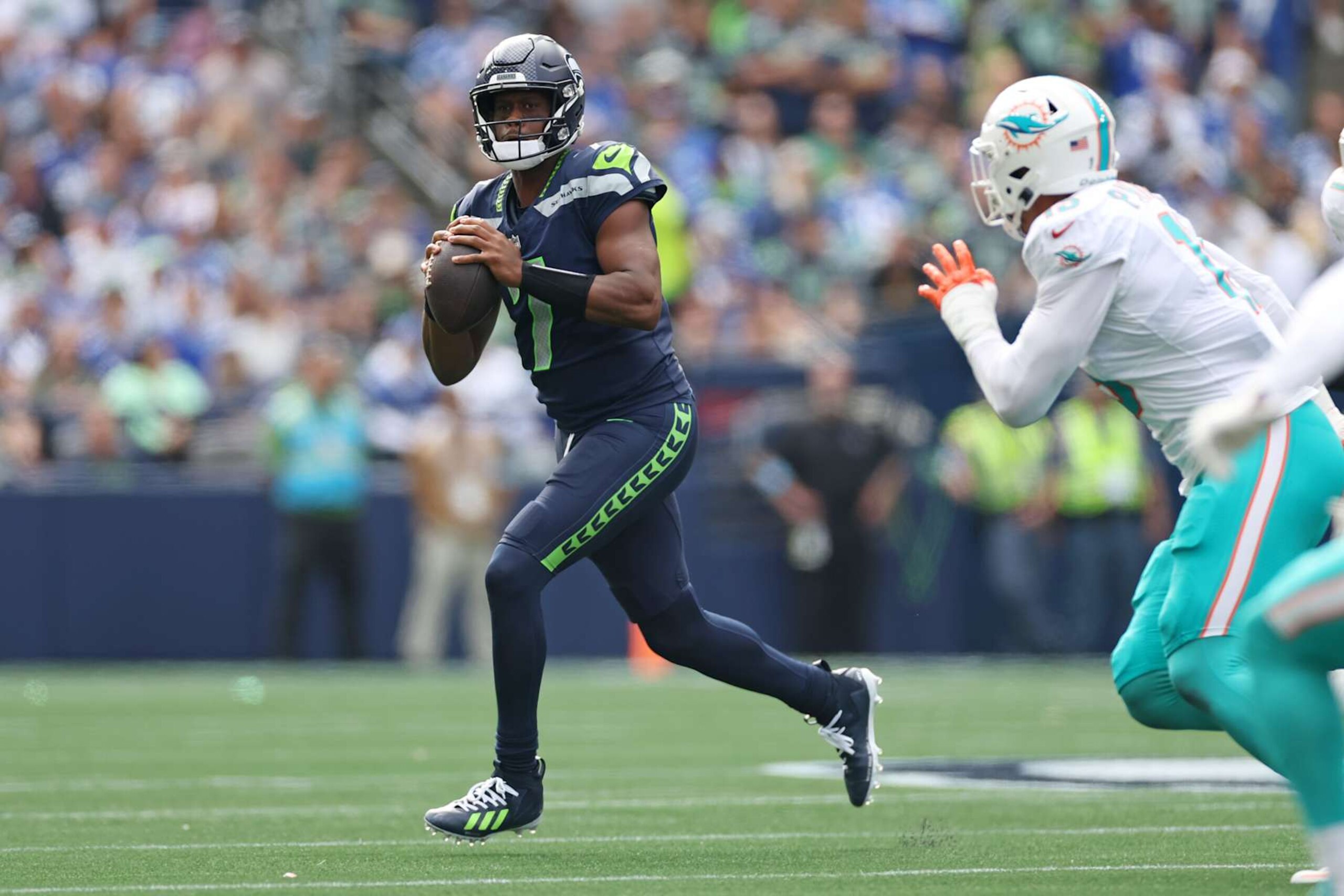 SEATTLE, WASHINGTON - SEPTEMBER 22: Geno Smith #7 of the Seattle Seahawks looks to pass during the second quarter against the Miami Dolphins at Lumen Field on September 22, 2024 in Seattle, Washington. (Photo by Steph Chambers/Getty Images) SEATTLE, WASHINGTON - SEPTEMBER 22: Geno Smith #7 of the Seattle Seahawks looks to pass during the second quarter against the Miami Dolphins at Lumen Field on September 22, 2024 in Seattle, Washington. (Photo by Steph Chambers/Getty Images)