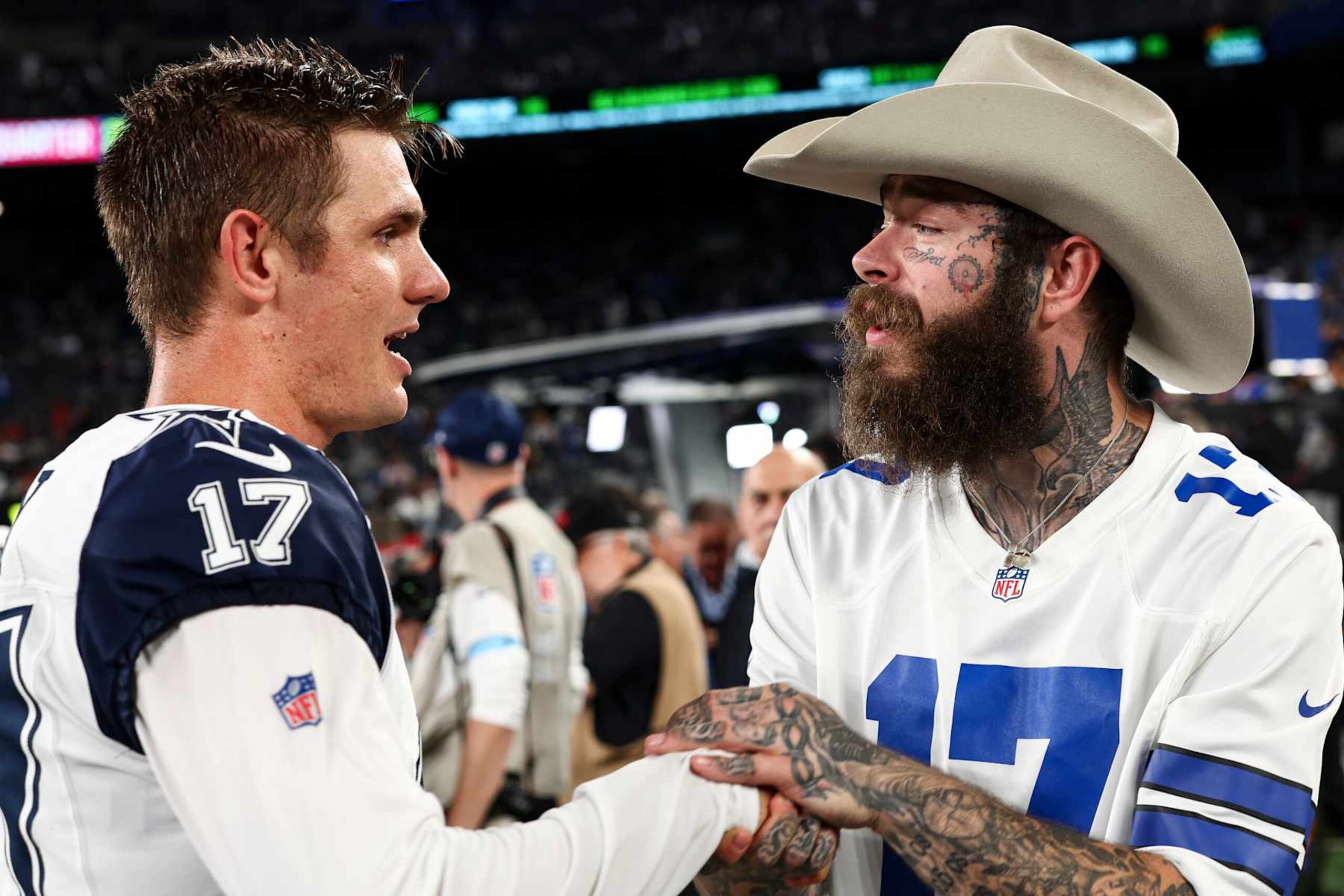 EAST RUTHERFORD, NJ - SEPTEMBER 26: Brandon Aubrey #17 of the Dallas Cowboys shakes hands with Post Malone prior to an NFL football game against the New York Giants at MetLife Stadium on September 26, 2024 in East Rutherford, New Jersey. (Photo by Kevin Sabitus/Getty Images)