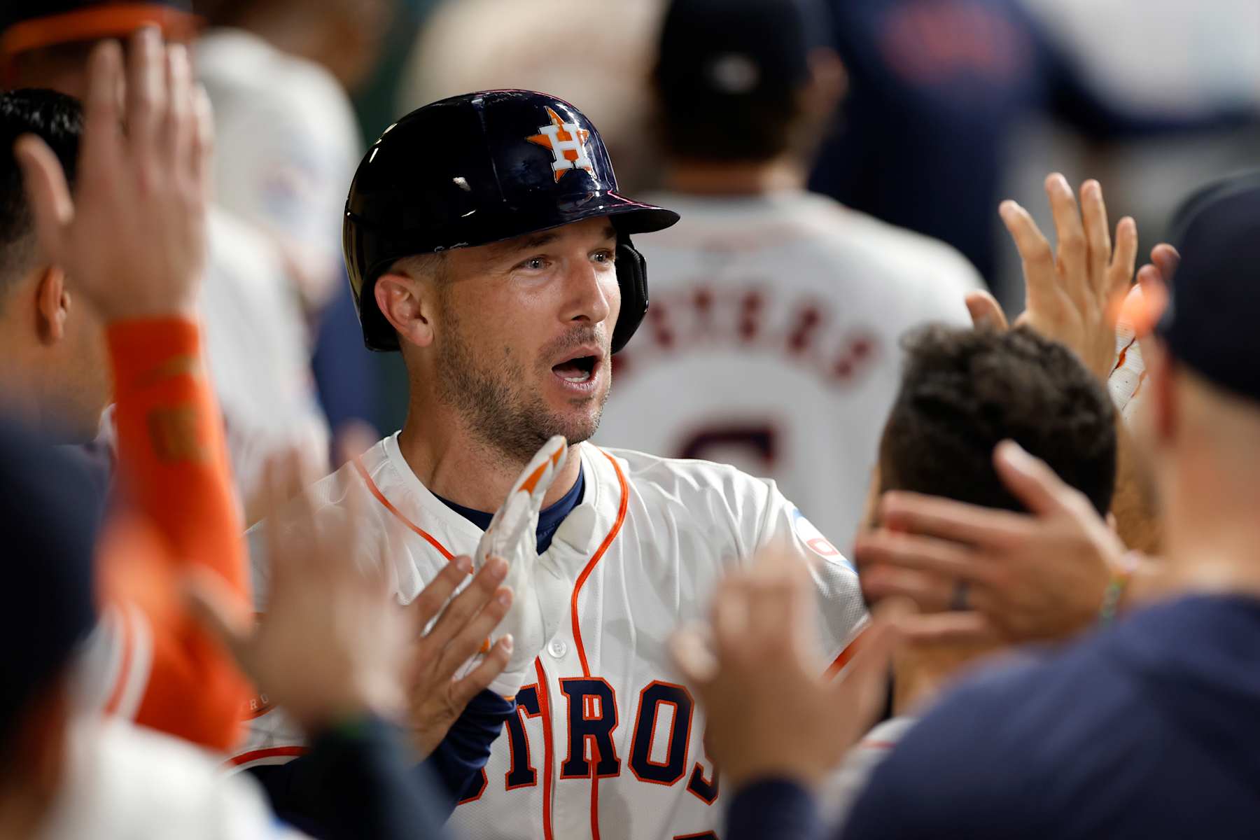 HOUSTON, TEXAS - SEPTEMBER 24: Alex Bregman #2 of the Houston Astros is congratulated in the dugout by teammates after hitting a solo home run in the first inning against the Seattle Mariners at Minute Maid Park on September 24, 2024 in Houston, Texas. (Photo by Tim Warner/Getty Images)