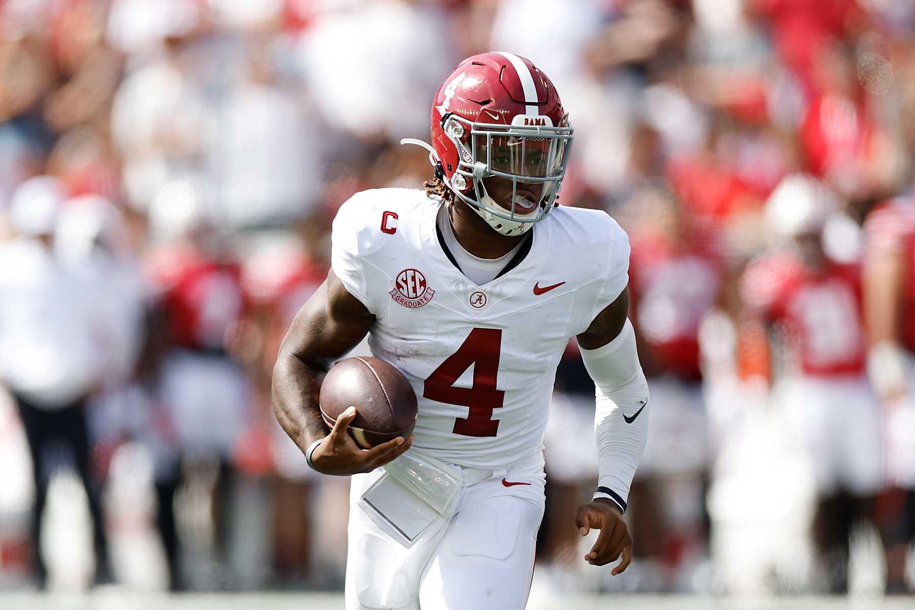 MADISON, WISCONSIN - SEPTEMBER 14: Jalen Milroe #4 of the Alabama Crimson Tide runs with the football during the game against the Wisconsin Badgers at Camp Randall Stadium on September 14, 2024 in Madison, Wisconsin. (Photo by John Fisher/Getty Images)