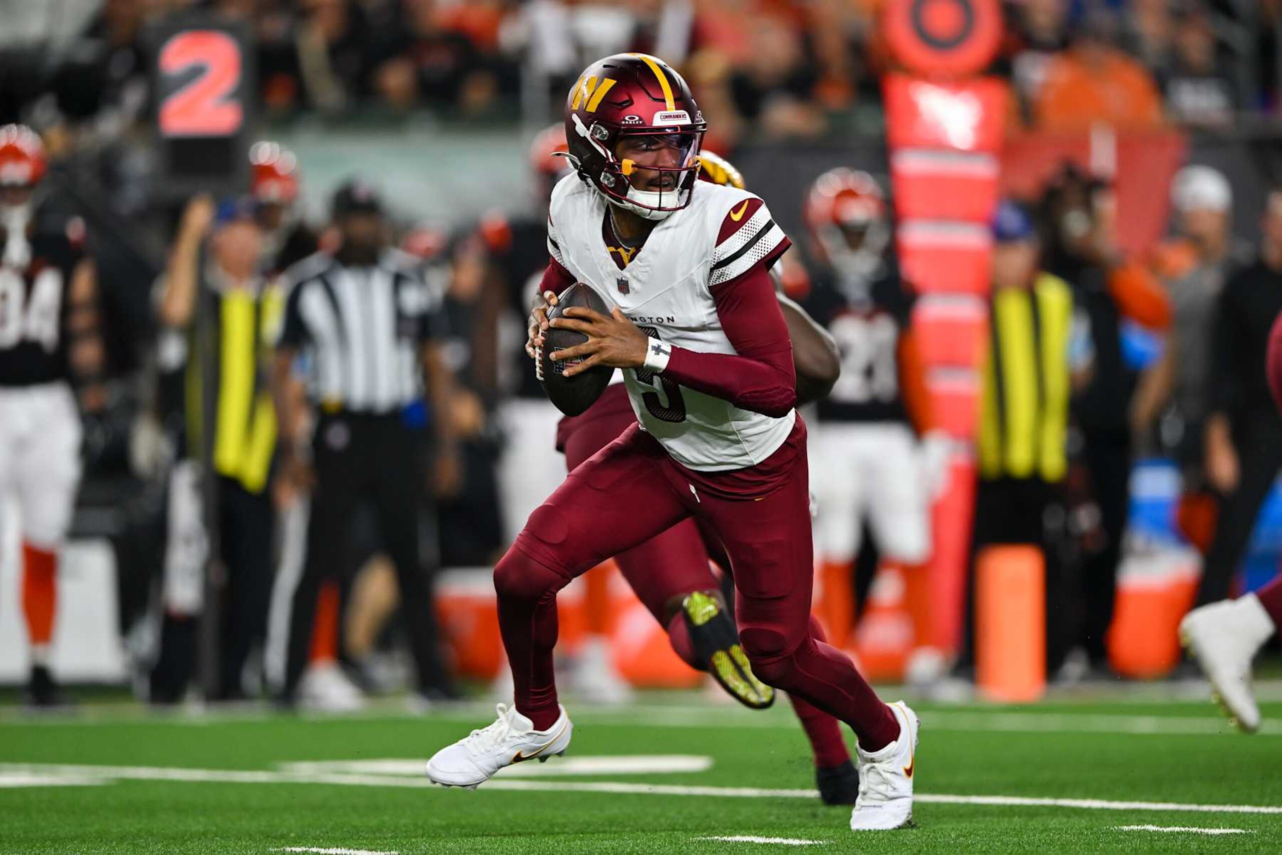 CINCINNATI, OHIO - SEPTEMBER 23: Jayden Daniels #5 of the Washington Commanders rolls out of the pocket during the game against the Cincinnati Bengals at Paycor Stadium on September 23, 2024 in Cincinnati, Ohio. The Commanders defeated the Bengals 38-33. (Photo by Alika Jenner/Getty Images)