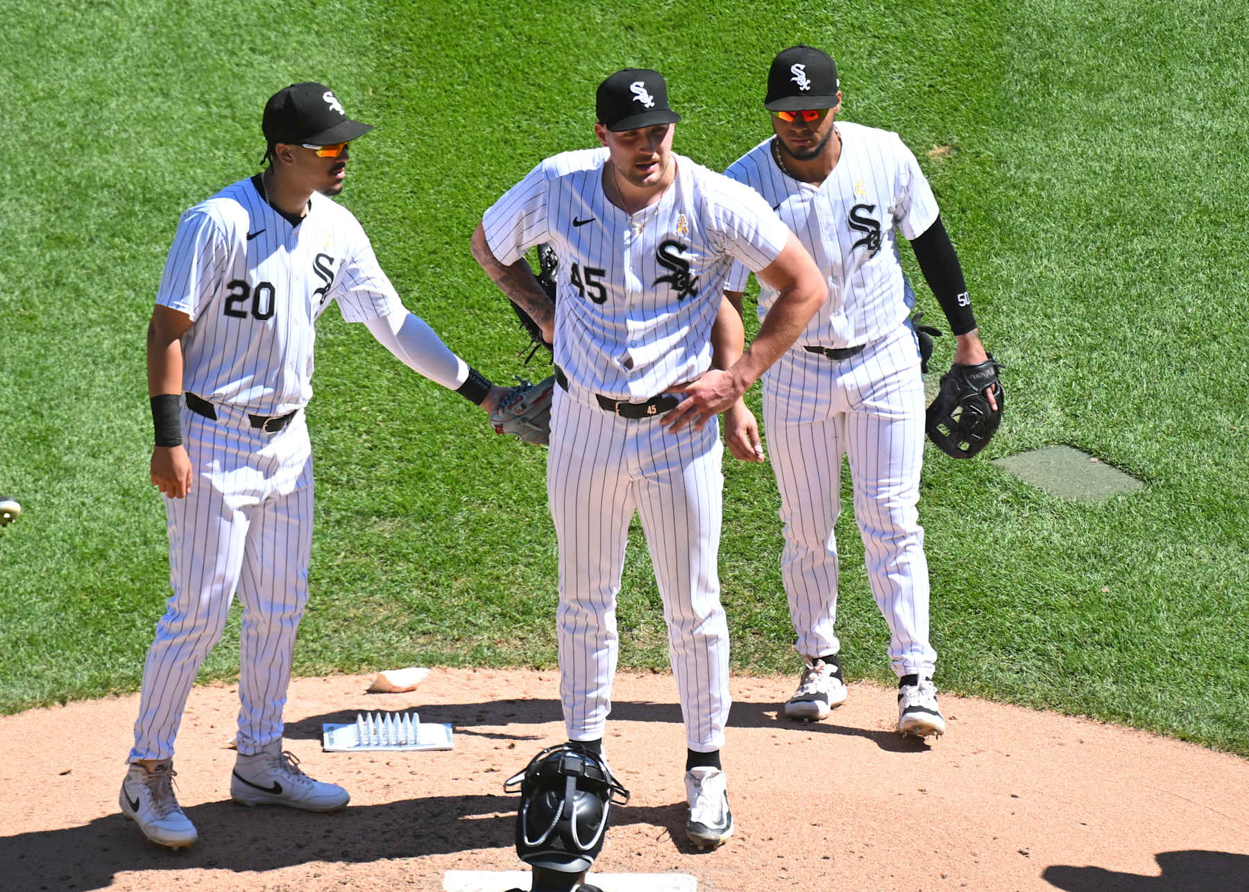 CHICAGO, ILLINOIS - SEPTEMBER 01: Garrett Crochet #45 of the Chicago White Sox reacts while Miguel Vargas #20 and Lenyn Sosa #50 of the Chicago White Sox show their support during the fourth inning against the New York Mets at Guaranteed Rate Field on September 01, 2024 in Chicago, Illinois. The Mets defeated the White Sox 2-0.  (Photo by Nuccio DiNuzzo/Getty Images)
