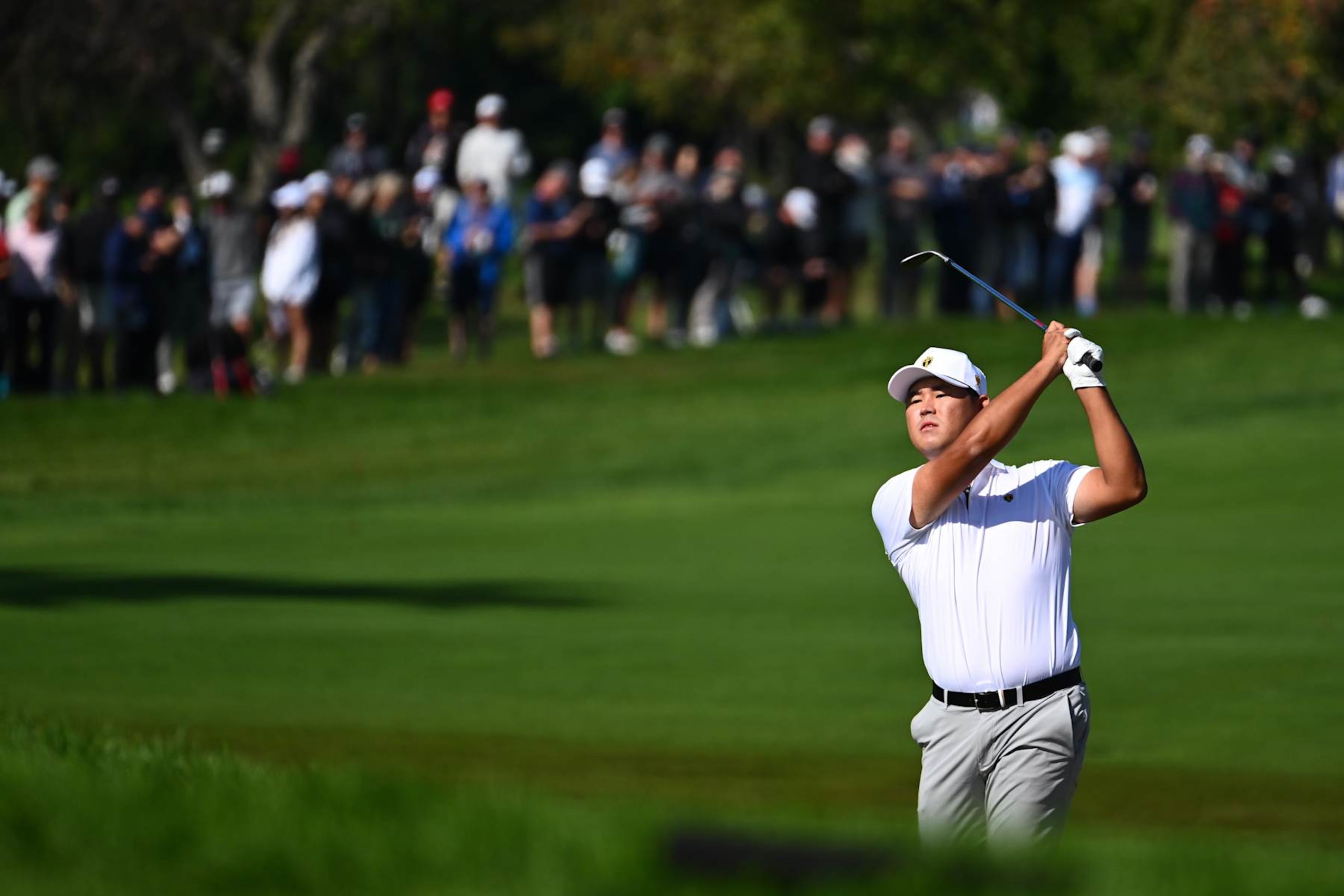 MONTREAL, QUEBEC - SEPTEMBER 28: Si Woo Kim of the International Team hits an approach shot on the ninth hole during Four-Ball matches on day three of the 2024 Presidents Cup at The Royal Montreal Golf Club on September 28, 2024 in Montreal, Quebec. (Photo by Tracy Wilcox/PGA TOUR via Getty Images)