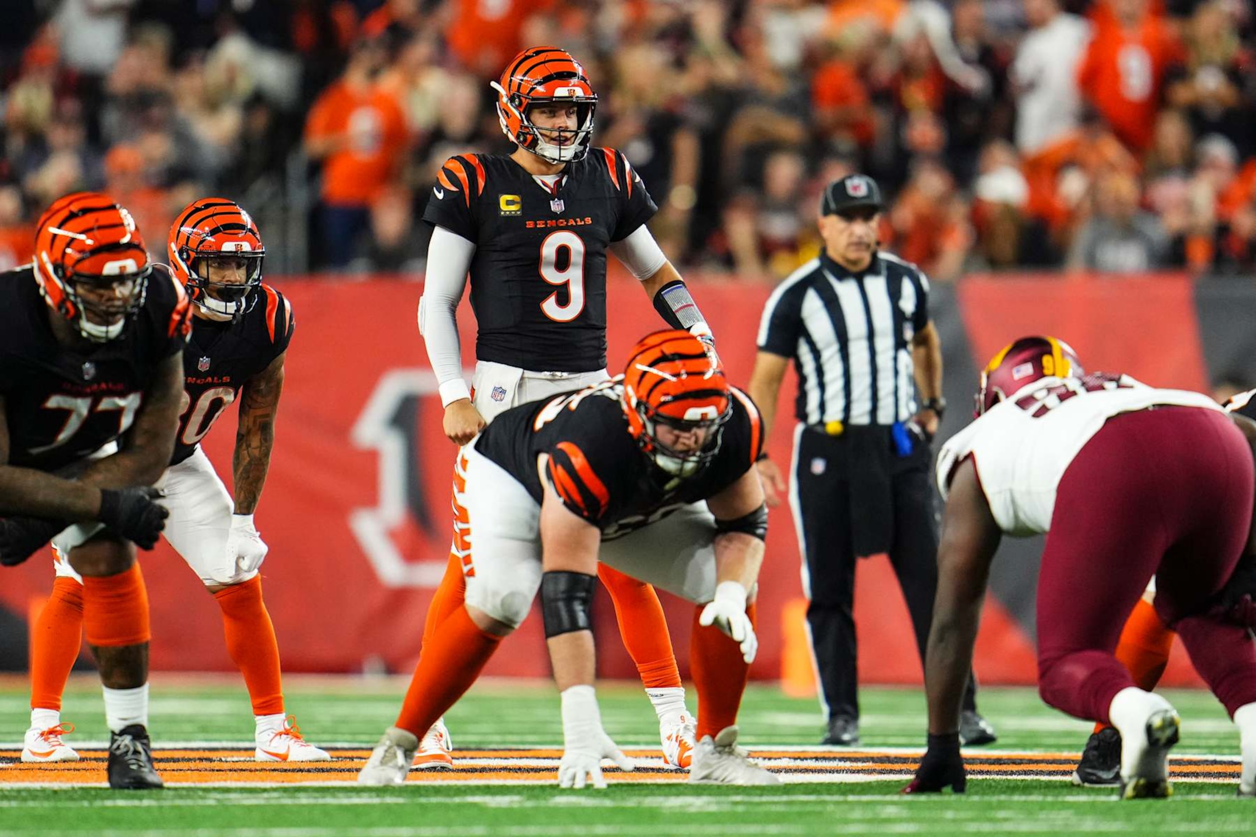 CINCINNATI, OH - SEPTEMBER 23: Joe Burrow #9 of the Cincinnati Bengals lines up before the snap during an NFL football game against the Washington Commanders at Paycor Stadium on September 23, 2024 in Cincinnati, Ohio. (Photo by Cooper Neill/Getty Images) CINCINNATI, OH - SEPTEMBER 23: Joe Burrow #9 of the Cincinnati Bengals lines up before the snap during an NFL football game against the Washington Commanders at Paycor Stadium on September 23, 2024 in Cincinnati, Ohio. (Photo by Cooper Neill/Getty Images)