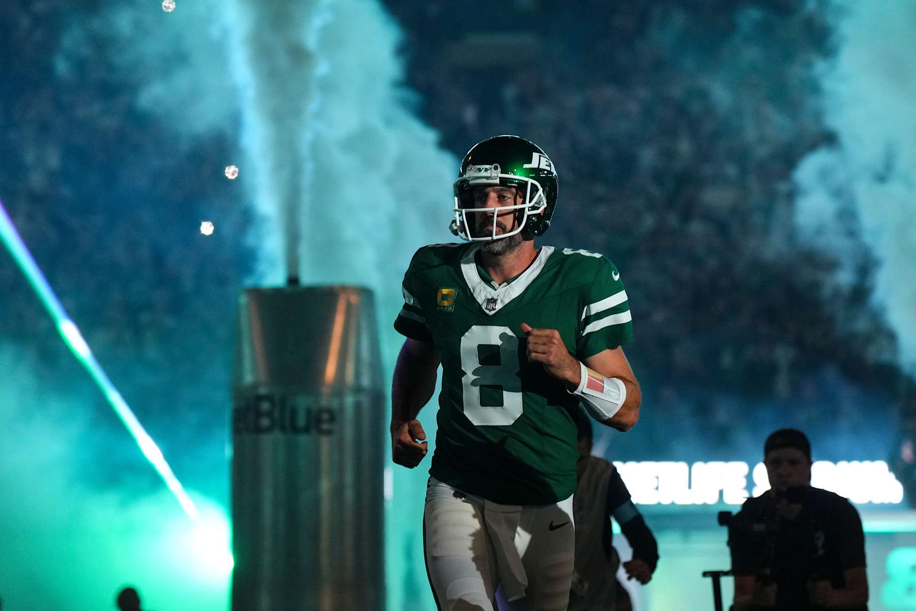 EAST RUTHERFORD, NJ - SEPTEMBER 19: Aaron Rodgers #8 of the New York Jets runs out of the tunnel prior to an NFL football game against the New England Patriots at MetLife Stadium on September 19, 2024 in East Rutherford, New Jersey. (Photo by Cooper Neill/Getty Images)