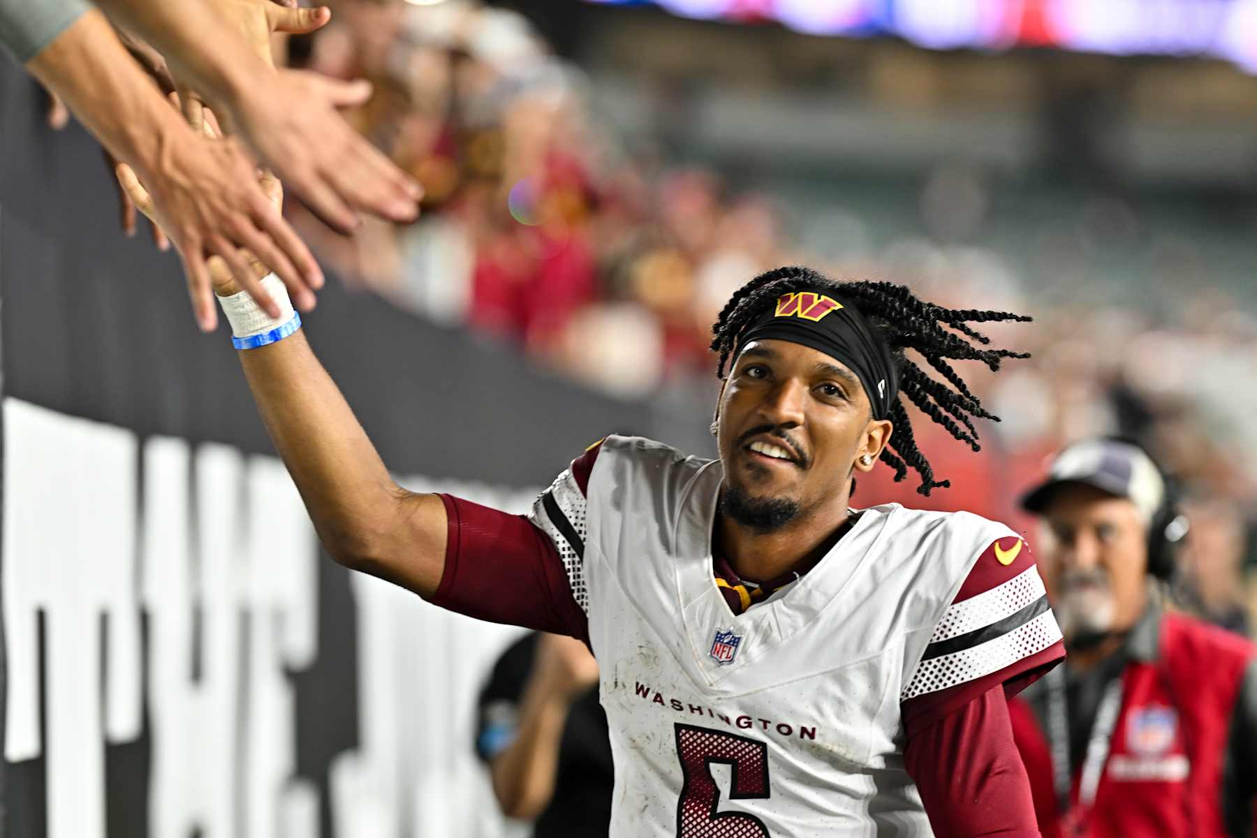 CINCINNATI, OHIO - SEPTEMBER 23: Jayden Daniels #5 of the Washington Commanders shakes hands with fans after the game against the Cincinnati Bengals at Paycor Stadium on September 23, 2024 in Cincinnati, Ohio. The Commanders defeated the Bengals 38-33. (Photo by Alika Jenner/Getty Images)