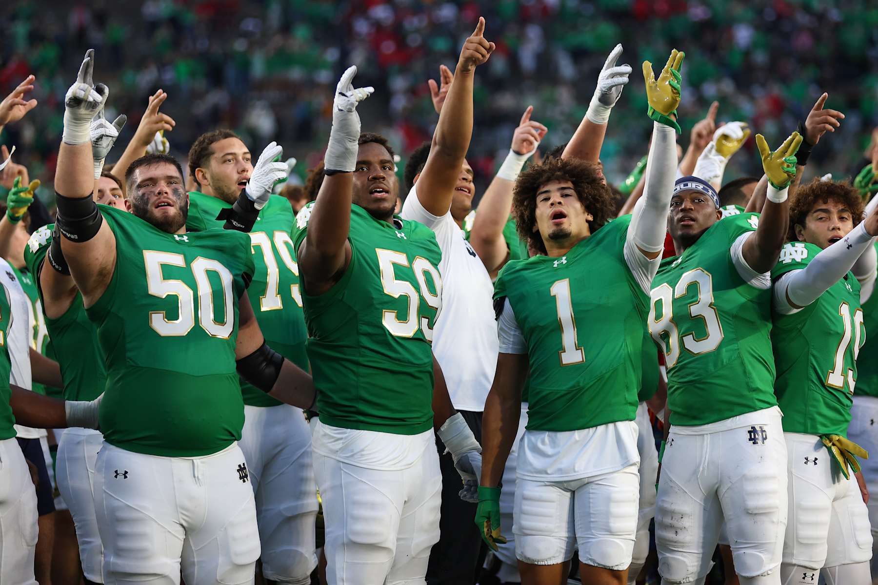 SOUTH BEND, INDIANA - SEPTEMBER 28: Rocco Spindler #50, Aamil Wagner #59, Jaden Greathouse #1 and Jayden Thomas #83 of the Notre Dame Fighting Irish celebrate after defeating the Louisville Cardinals at Notre Dame Stadium on September 28, 2024 in South Bend, Indiana. (Photo by Michael Reaves/Getty Images)