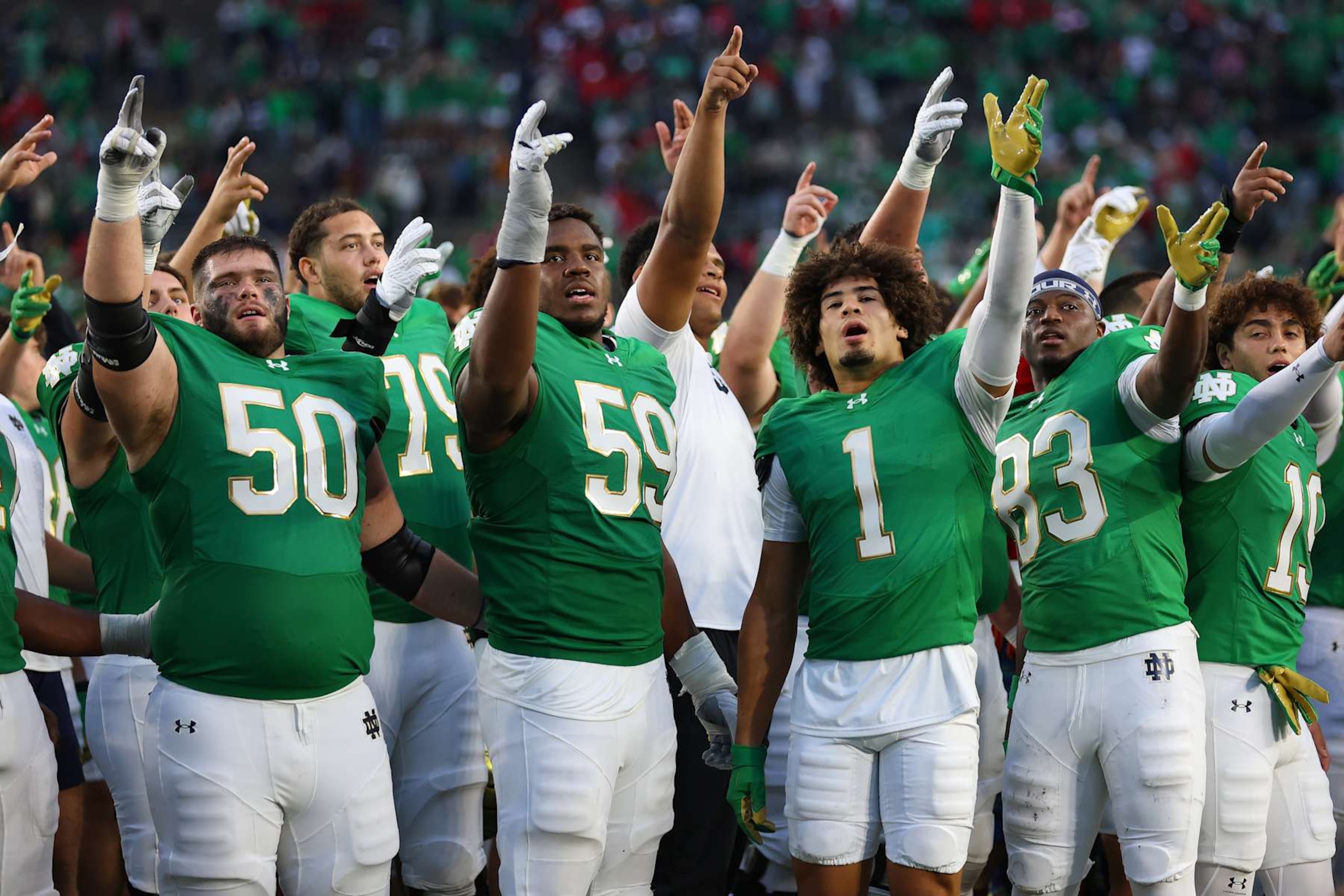SOUTH BEND, INDIANA - SEPTEMBER 28: Rocco Spindler #50, Aamil Wagner #59, Jaden Greathouse #1 and Jayden Thomas #83 of the Notre Dame Fighting Irish celebrate after defeating the Louisville Cardinals at Notre Dame Stadium on September 28, 2024 in South Bend, Indiana. (Photo by Michael Reaves/Getty Images)