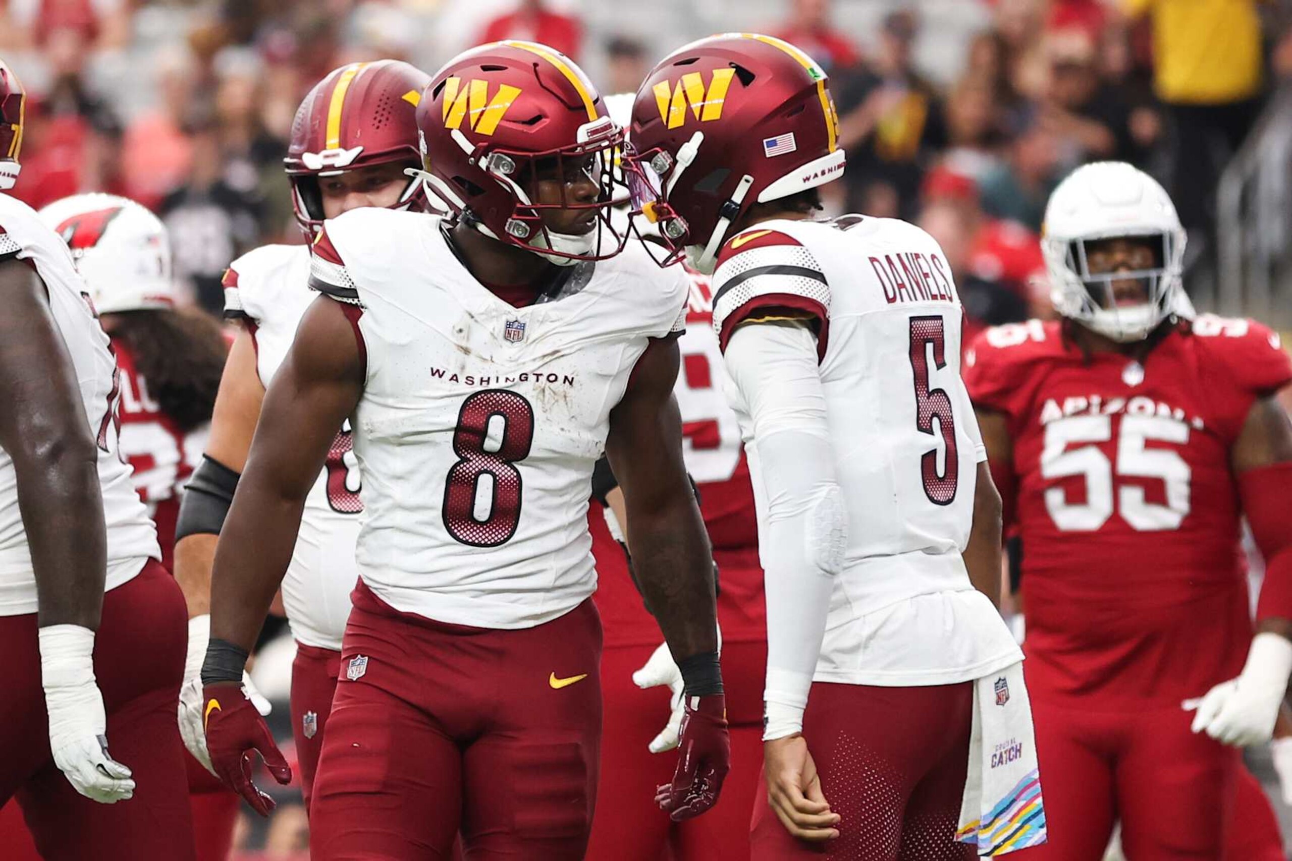 GLENDALE, ARIZONA - SEPTEMBER 29: Brian Robinson Jr. #8 of the Washington Commanders celebrates his touchdown run with Jayden Daniels #5 during the first quarter against the Arizona Cardinals at State Farm Stadium on September 29, 2024 in Glendale, Arizona. (Photo by Christian Petersen/Getty Images)