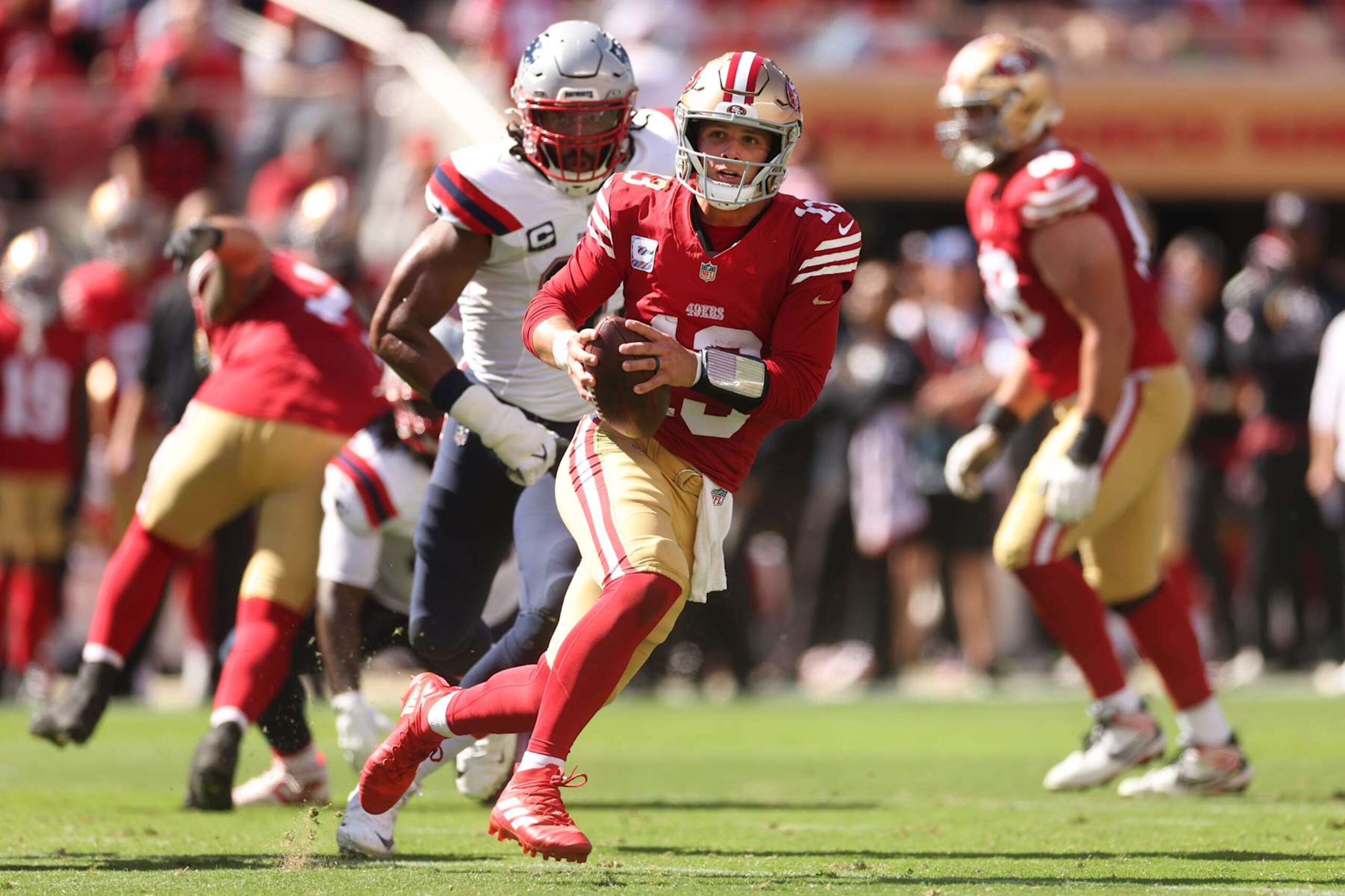 SANTA CLARA, CALIFORNIA - SEPTEMBER 29: Brock Purdy #13 of the San Francisco 49ers runs with the ball in the second quarter against the New England Patriots at Levi's Stadium on September 29, 2024 in Santa Clara, California. (Photo by Ezra Shaw/Getty Images)