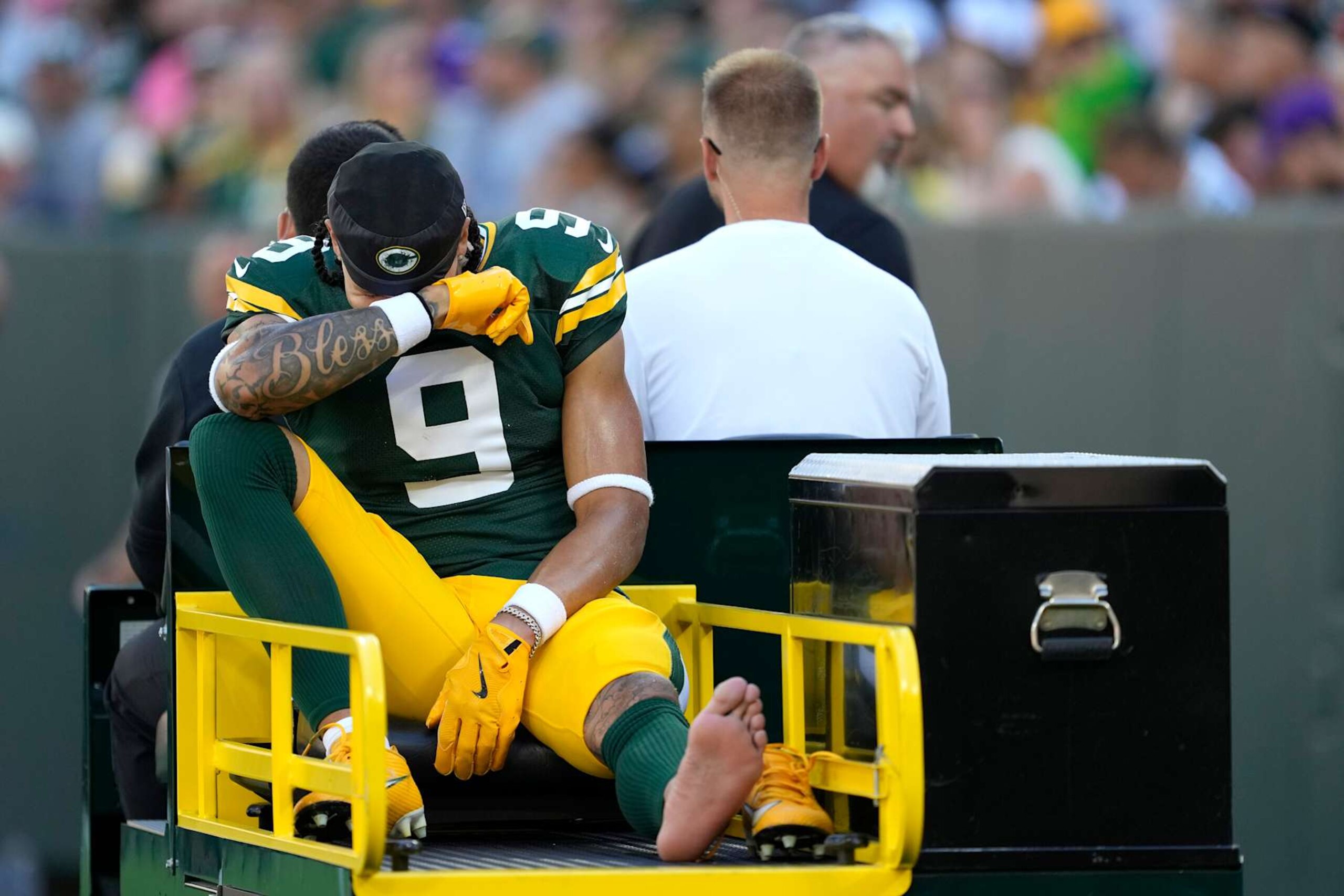 GREEN BAY, WISCONSIN - SEPTEMBER 29: Christian Watson #9 of the Green Bay Packers is carted off the field after an apparent injury during the first half of the game against the Minnesota Vikings at Lambeau Field on September 29, 2024 in Green Bay, Wisconsin. (Photo by Patrick McDermott/Getty Images)