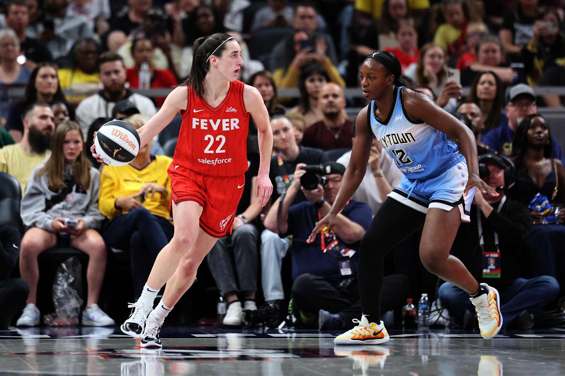 INDIANAPOLIS, INDIANA - JUNE 01: Caitlin Clark #22 of the Indiana Fever dribbles against Michaela Onyenwere #12 of the Chicago Sky during the third quarter in the game at Gainbridge Fieldhouse on June 01, 2024 in Indianapolis, Indiana. NOTE TO USER: User expressly acknowledges and agrees that, by downloading and or using this photograph, User is consenting to the terms and conditions of the Getty Images License Agreement. (Photo by Andy Lyons/Getty Images)