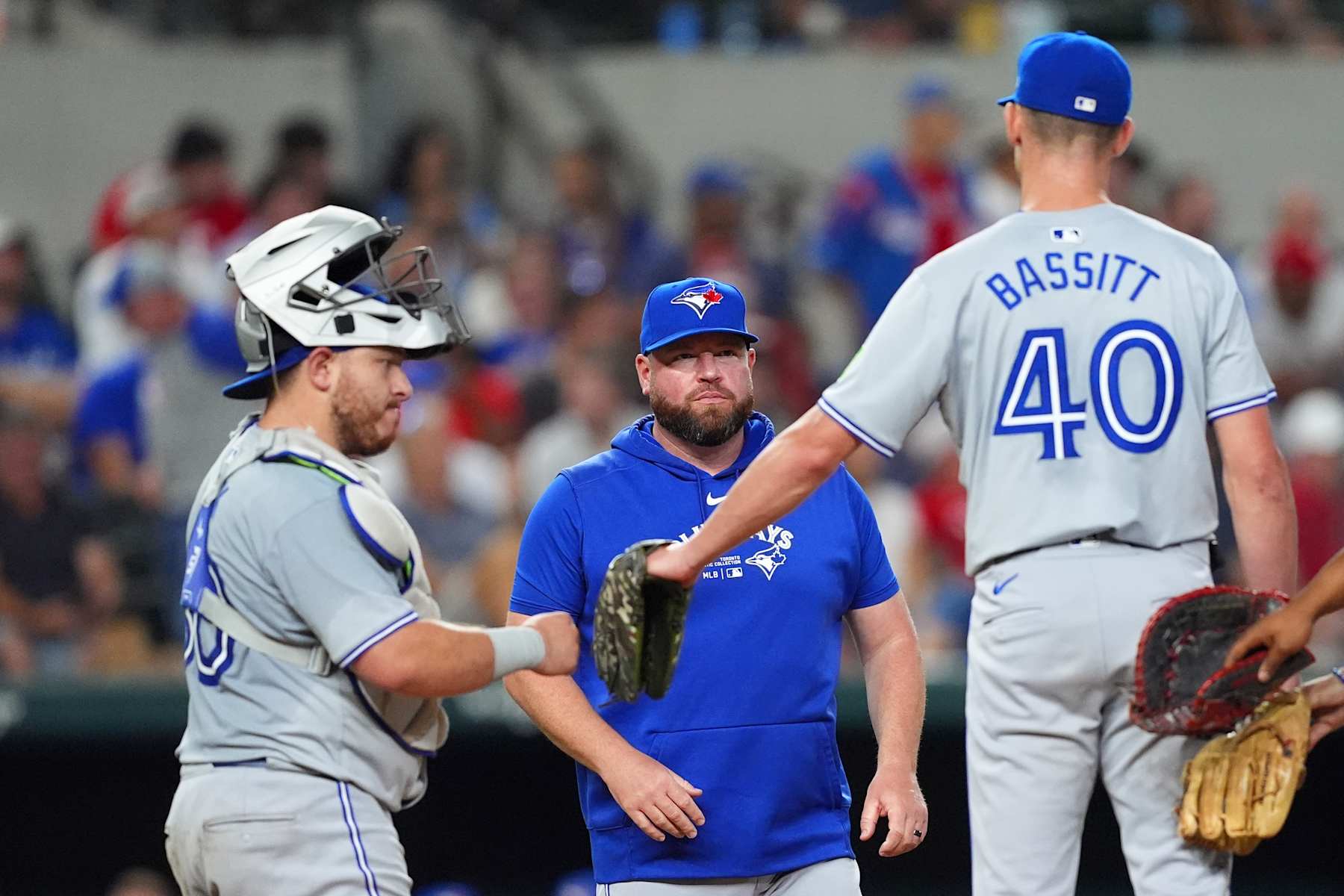 Alejandro Kirk (L), John Schneider (C) and Chris Bassitt (R)