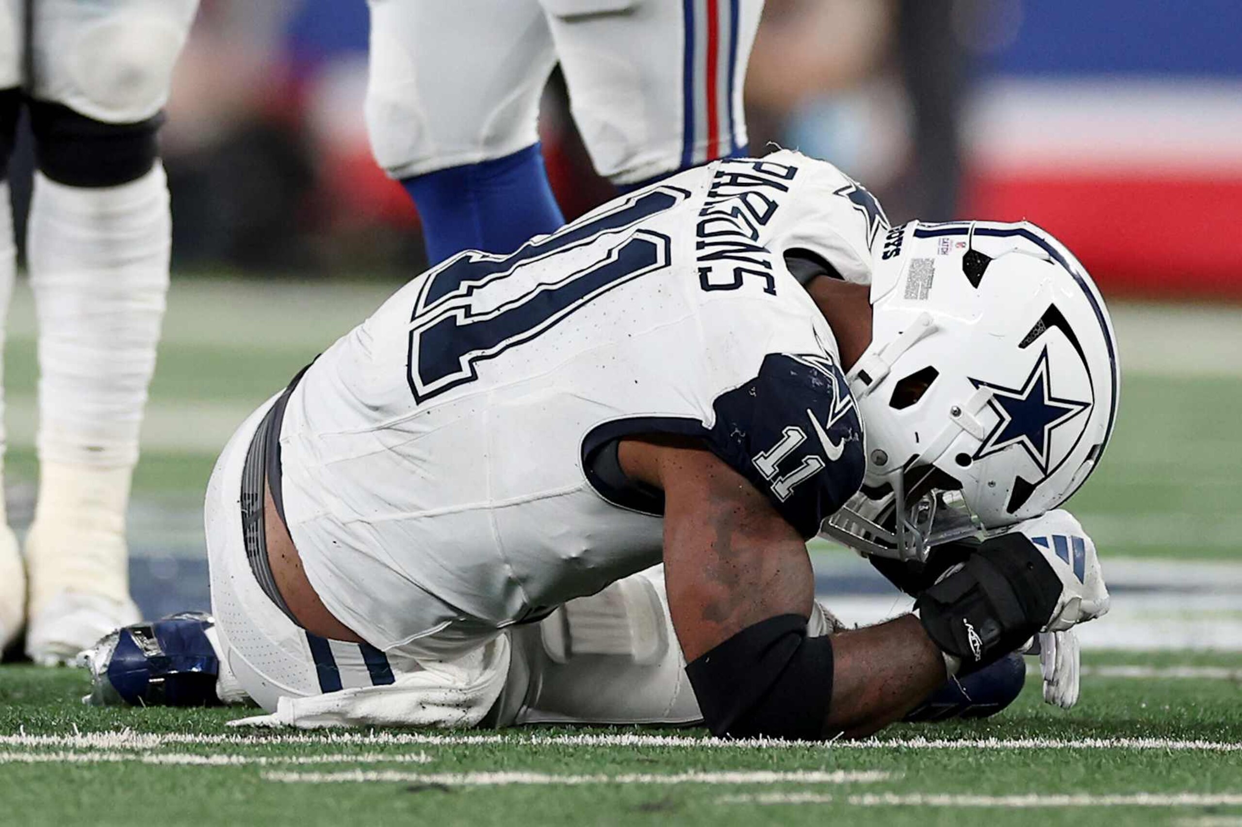 EAST RUTHERFORD, NEW JERSEY - SEPTEMBER 26: Micah Parsons #11 of the Dallas Cowboys reacts on the ground after play the fourth quarter against the New York Giants at MetLife Stadium on September 26, 2024 in East Rutherford, New Jersey. (Photo by Luke Hales/Getty Images)
