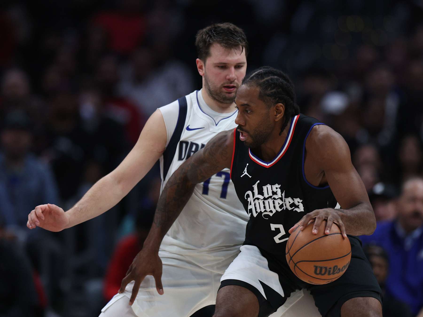 LOS ANGELES, CALIFORNIA - APRIL 23: Luka Doncic #77 of the Dallas Mavericks guards Kawhi Leonard #2 of the LA Clippers during a 96-93 Dallas Mavericks win in game two of the Western Conference First Round Playoffs at Crypto.com Arena on April 23, 2024 in Los Angeles, California. User is consenting to the terms and conditions of the Getty Images License Agreement. (Photo by Harry How/Getty Images)