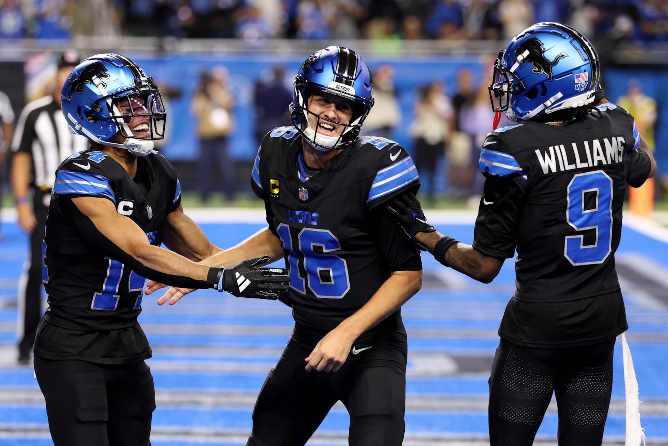 DETROIT, MICHIGAN - SEPTEMBER 30: Jared Goff #16 of the Detroit Lions celebrates with Amon-Ra St. Brown #14 and Jameson Williams #9 after catching a touchdown pass against the Seattle Seahawks during the third quarter at Ford Field on September 30, 2024 in Detroit, Michigan. (Photo by Gregory Shamus/Getty Images)