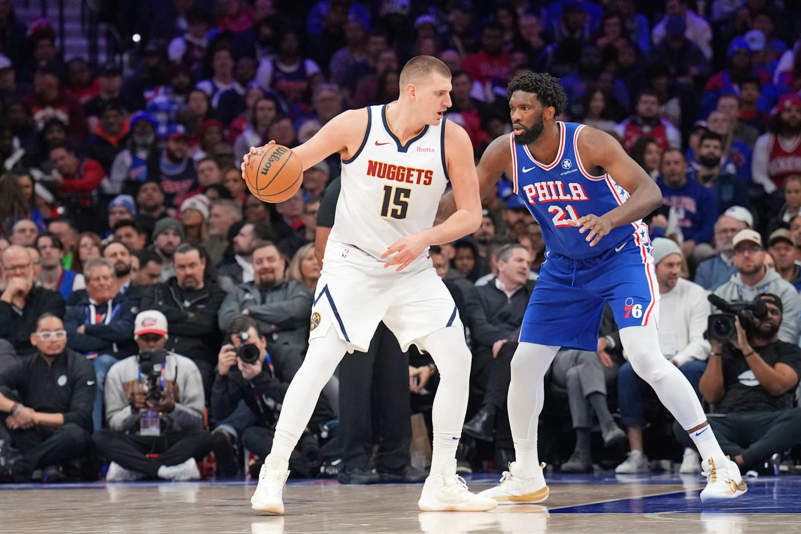 PHILADELPHIA, PA - JANUARY 16: Nikola Jokic #15 of the Denver Nuggets dribbles the ball during the game against defender Joel Embiid #21 of the Philadelphia 76ers on January 16, 2023 at the Wells Fargo Center in Philadelphia, Pennsylvania NOTE TO USER: User expressly acknowledges and agrees that, by downloading and/or using this Photograph, user is consenting to the terms and conditions of the Getty Images License Agreement. Mandatory Copyright Notice: Copyright 2024 NBAE (Photo by Jesse D. Garrabrant/NBAE via Getty Images)