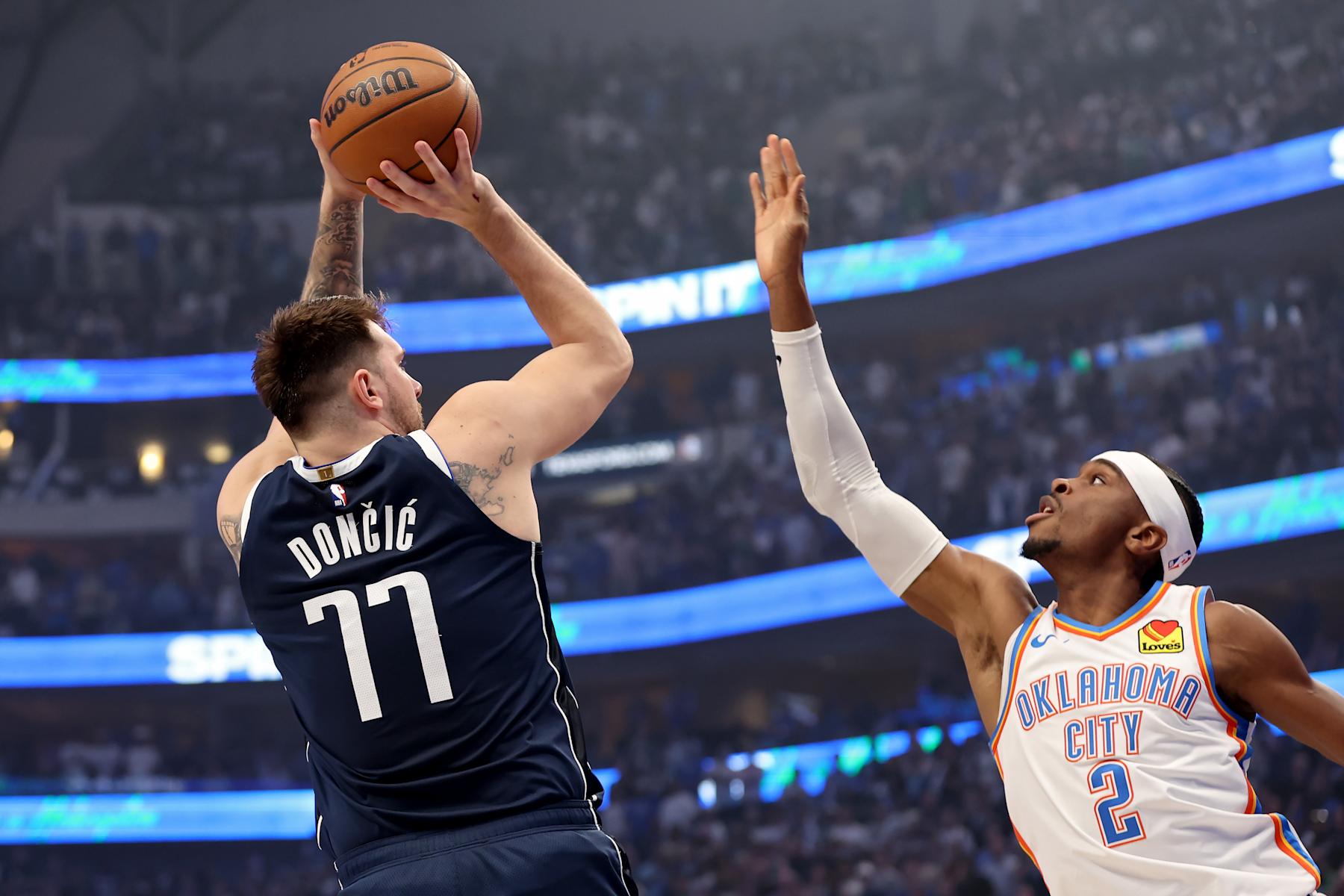 DALLAS, TEXAS - MAY 13: Luka Doncic #77 of the Dallas Mavericks shoots over Shai Gilgeous-Alexander #2 of the Oklahoma City Thunder during the first quarter in Game Four of the Western Conference Second Round Playoffs at American Airlines Center on May 13, 2024 in Dallas, Texas. NOTE TO USER: User expressly acknowledges and agrees that, by downloading and or using this photograph, User is consenting to the terms and conditions of the Getty Images License Agreement. (Photo by Tim Heitman/Getty Images)
