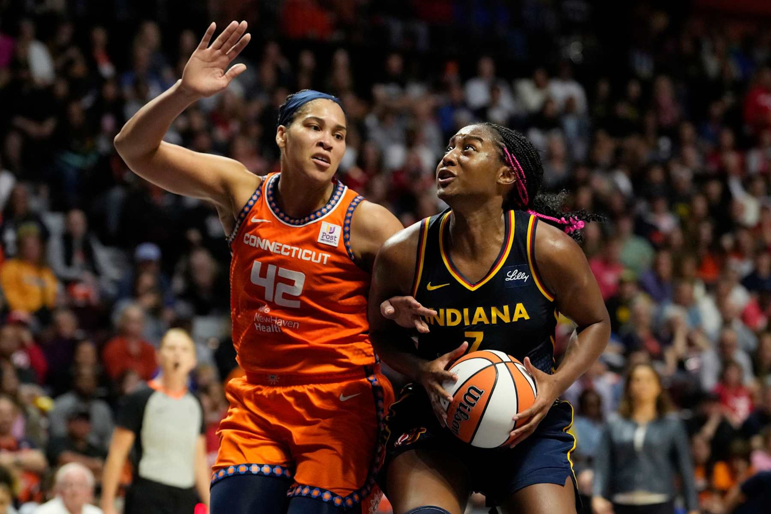 UNCASVILLE, CONNECTICUT - SEPTEMBER 22: Aliyah Boston #7 of the Indiana Fever is defended by Brionna Jones #42 of the Connecticut Sun during the second half of a first round WNBA playoff game at Mohegan Sun Arena on September 22, 2024 in Uncasville, Connecticut. The Sun defeated the Fever 93-69. NOTE TO USER: User expressly acknowledges and agrees that, by downloading and or using this photograph, User is consenting to the terms and conditions of the Getty Images License Agreement. (Photo by Joe Buglewicz/Getty Images)