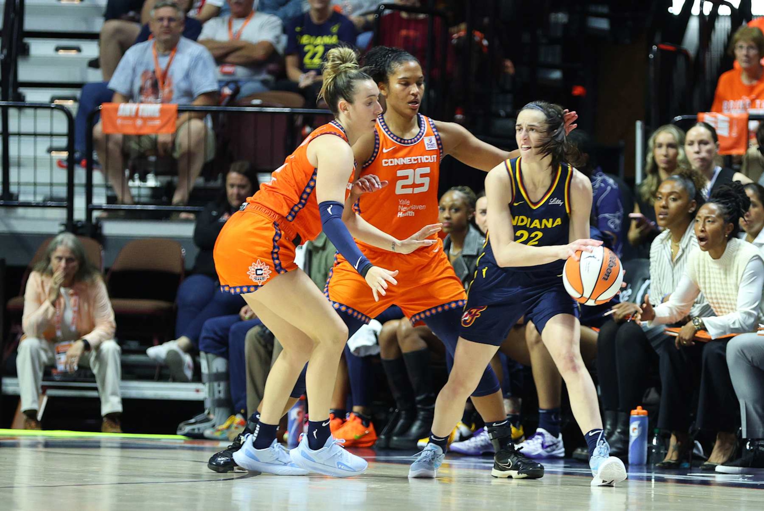 UNCASVILLE, CT - SEPTEMBER 22: Indiana Fever guard Caitlin Clark (22) doubled-teamed by Connecticut Sun forward Alyssa Thomas (25) and Connecticut Sun guard Marina Mabrey (4) during the First Round and game 1 of the 2024 WNBA playoffs between Indiana Fever and Connecticut Sun on September 22, 2024, at Mohegan Sun Arena in Uncasville, CT. (Photo by M. Anthony Nesmith/Icon Sportswire via Getty Images)