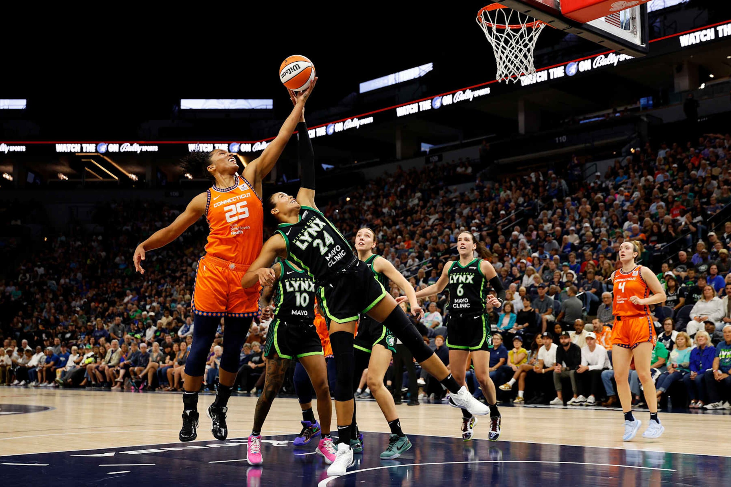 MINNEAPOLIS, MINNESOTA - SEPTEMBER 29: Alyssa Thomas #25 of the Connecticut Sun and Napheesa Collier #24 of the Minnesota Lynx compete for a rebound in the first quarter of Game One of the Semi-Finals during the WNBA Playoffs at Target Center on September 29, 2024 in Minneapolis, Minnesota. (Photo by David Berding/Getty Images)