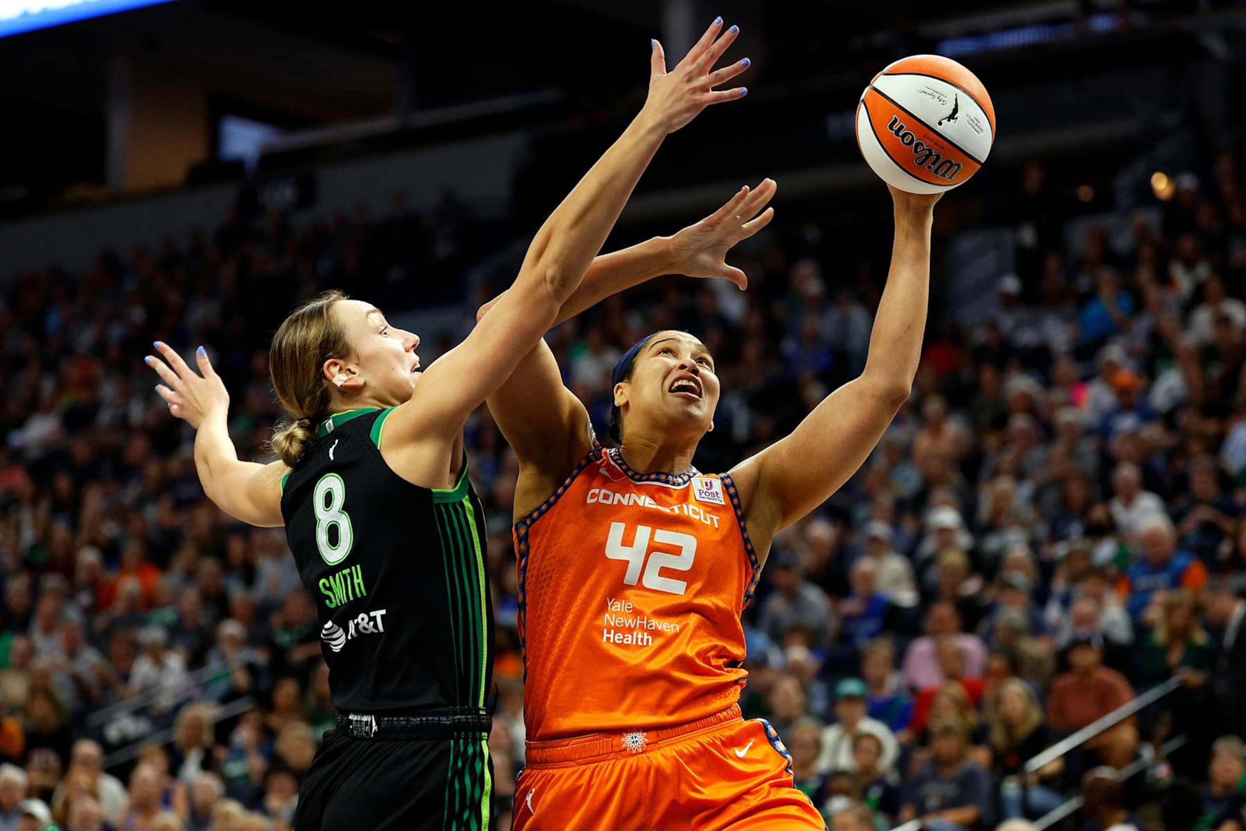 MINNEAPOLIS, MINNESOTA - SEPTEMBER 29: Brionna Jones #42 of the Connecticut Sun goes up for a shot against Alanna Smith #8 of the Minnesota Lynx in the first quarter of Game One of the Semi-Finals during the WNBA Playoffs at Target Center on September 29, 2024 in Minneapolis, Minnesota. (Photo by David Berding/Getty Images)