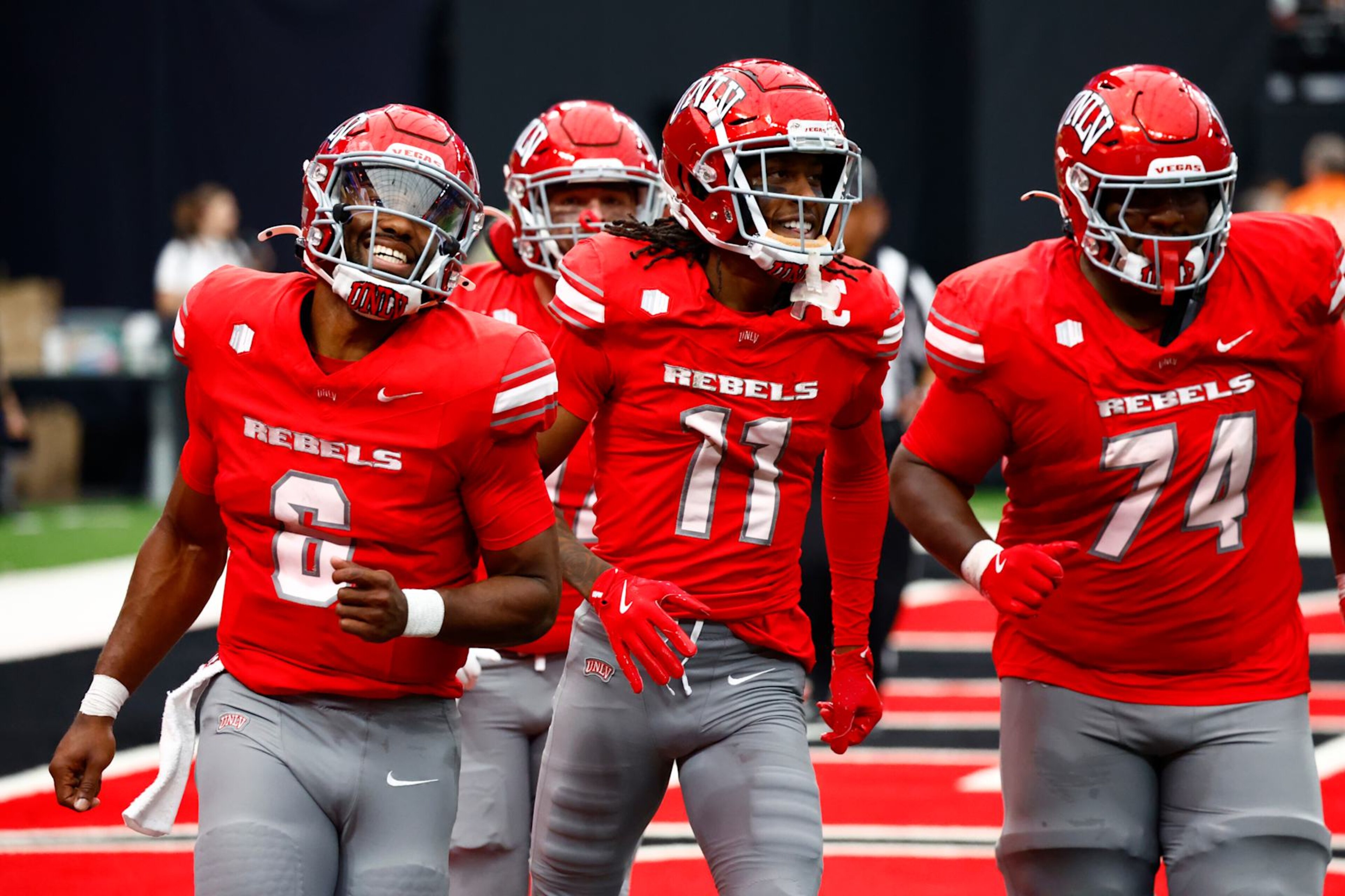 LAS VEGAS, NV - SEPTEMBER 28: Quarterback Hajj-Malik Williams (6), wide receiver Ricky White III (11), and offensive lineman Jalen St. John (74) of the UNLV Rebels celebrate after a touchdown pass by Williams to White during a Mountain West Conference game between the Fresno State Bulldogs and the UNLV Rebels on September 28, 2024 at Allegiant Stadium in Las Vegas, Nevada. (Photo by Jeff Speer/Icon Sportswire via Getty Images)