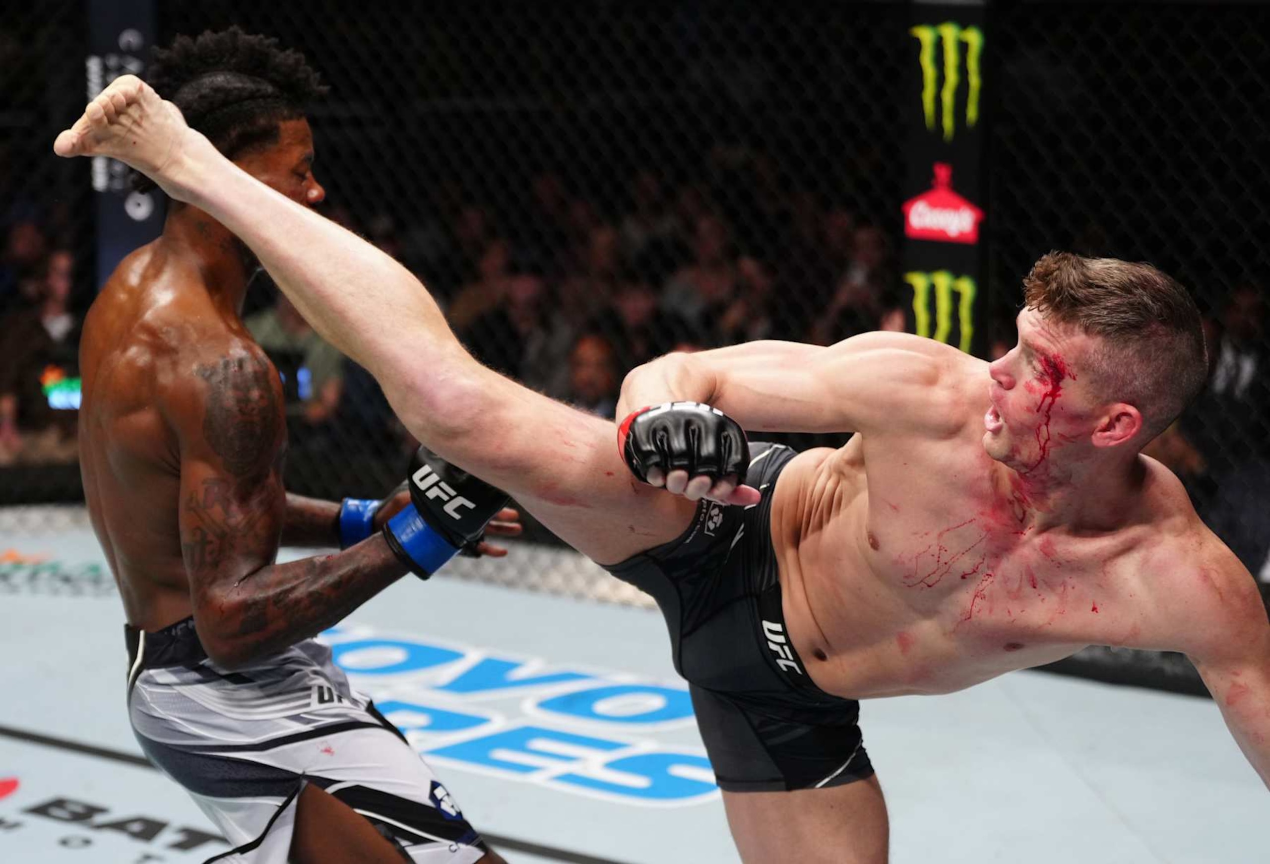 Thompson kicks Kevin Holland in a welterweight fight in 2022. 
