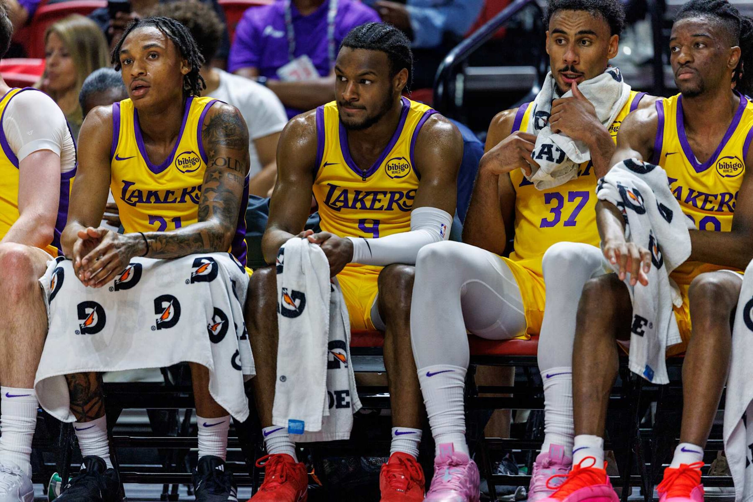 LAS VEGAS, NV - JULY 17, 2024: Los Angeles Lakers guard Bronny James (9) sits n the bench between Los Angeles Lakers forward Maxwell Lewis (21), left, and Los Angeles Lakers forward Armel Traore (37), right, during the game against the Atlanta Hawks in the NBA 2K25 Summer League game at the Thomas & Mack Center on July 17, 2024 in Las Vegas, Nevada.(Gina Ferazzi / Los Angeles Times via Getty Images) LAS VEGAS, NV - JULY 17, 2024: Los Angeles Lakers guard Bronny James (9) sits n the bench between Los Angeles Lakers forward Maxwell Lewis (21), left, and Los Angeles Lakers forward Armel Traore (37), right, during the game against the Atlanta Hawks in the NBA 2K25 Summer League game at the Thomas & Mack Center on July 17, 2024 in Las Vegas, Nevada.(Gina Ferazzi / Los Angeles Times via Getty Images)