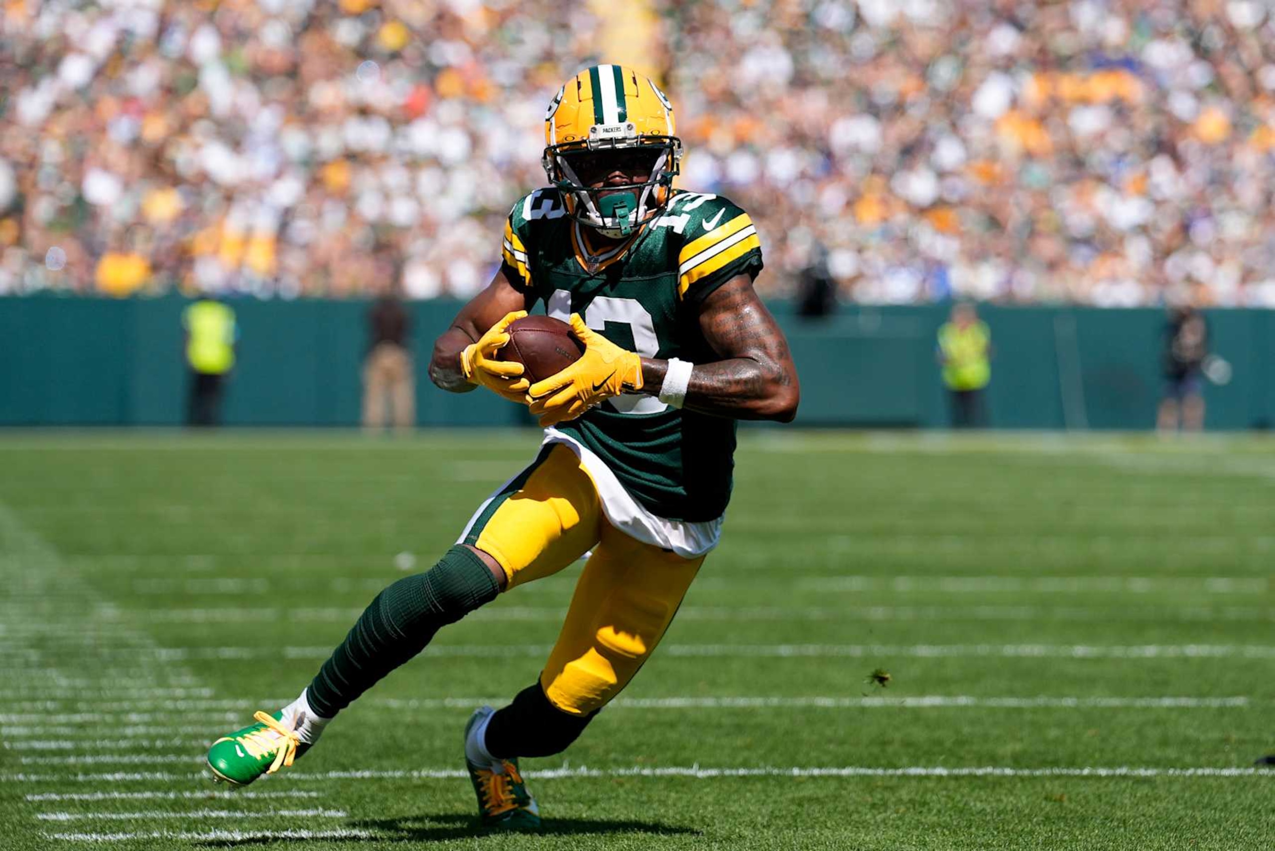 GREEN BAY, WISCONSIN - SEPTEMBER 15: Dontayvion Wicks #13 of the Green Bay Packers scores a touchdown against the Indianapolis Colts during the first quarter at Lambeau Field on September 15, 2024 in Green Bay, Wisconsin. (Photo by Patrick McDermott/Getty Images)