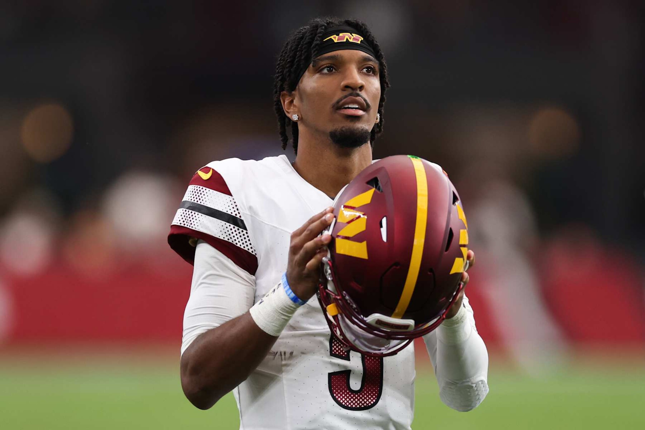 GLENDALE, ARIZONA - SEPTEMBER 29: Jayden Daniels #5 of the Washington Commanders looks on during the second half against the Arizona Cardinals at State Farm Stadium on September 29, 2024 in Glendale, Arizona. (Photo by Christian Petersen/Getty Images)
