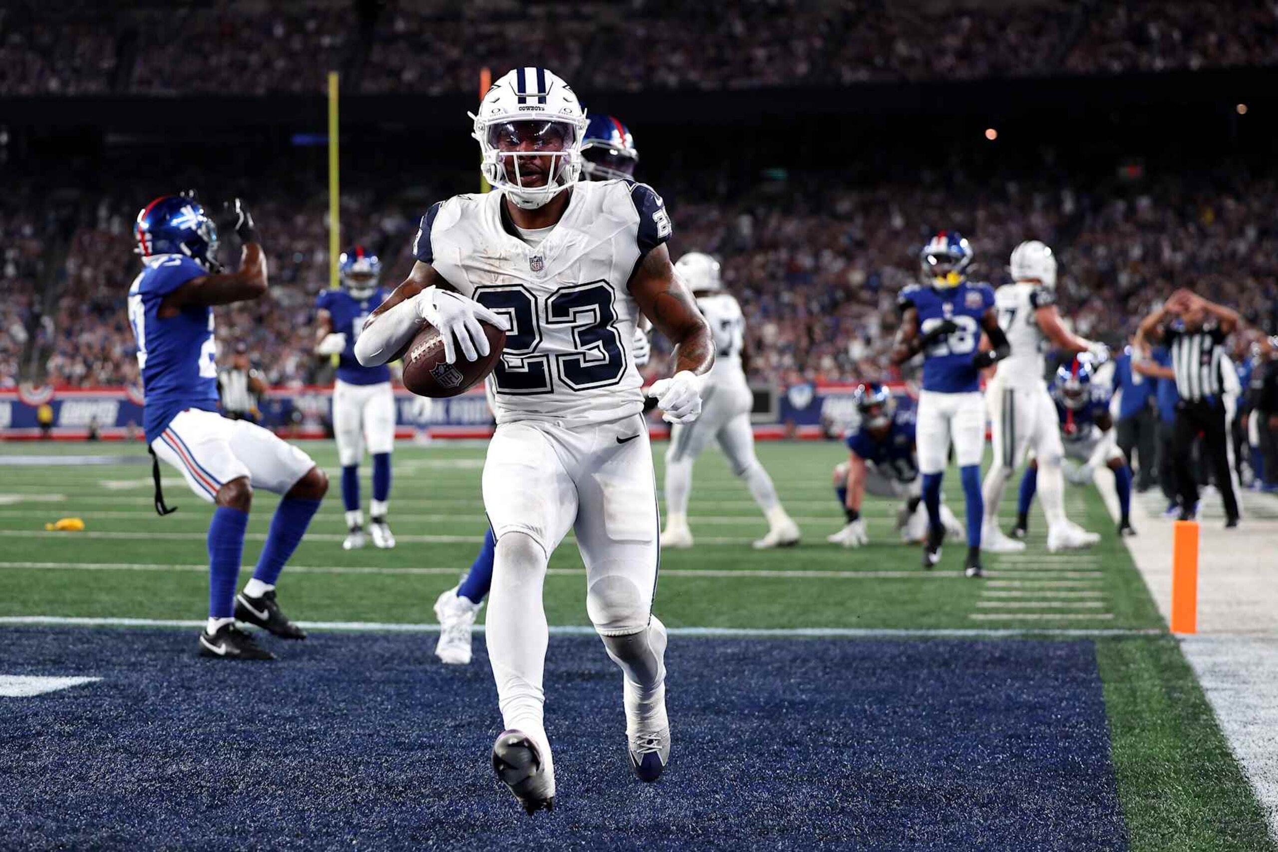 EAST RUTHERFORD, NEW JERSEY - SEPTEMBER 26: Rico Dowdle #23 of the Dallas Cowboys scores a touchdown against the New York Giants during the first quarter at MetLife Stadium on September 26, 2024 in East Rutherford, New Jersey. (Photo by Luke Hales/Getty Images)