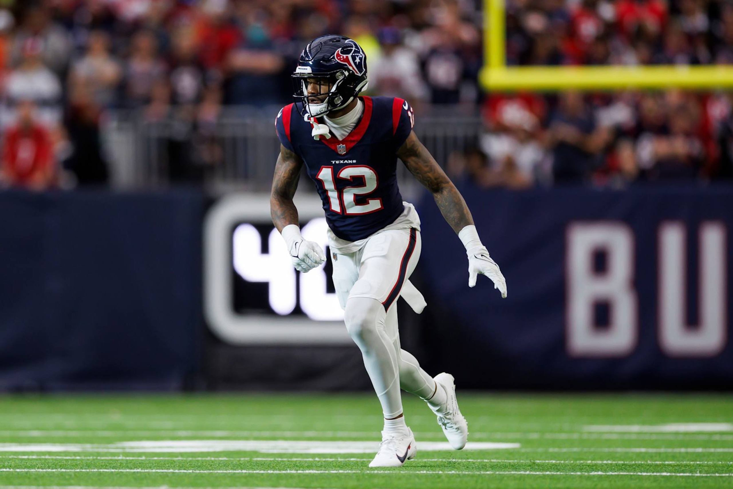 HOUSTON, TEXAS - JANUARY 13: Nico Collins #12 of the Houston Texans runs a route during an AFC wild-card playoff football game against the Cleveland Browns at NRG Stadium on January 13, 2024 in Houston, Texas. (Photo by Ryan Kang/Getty Images)
