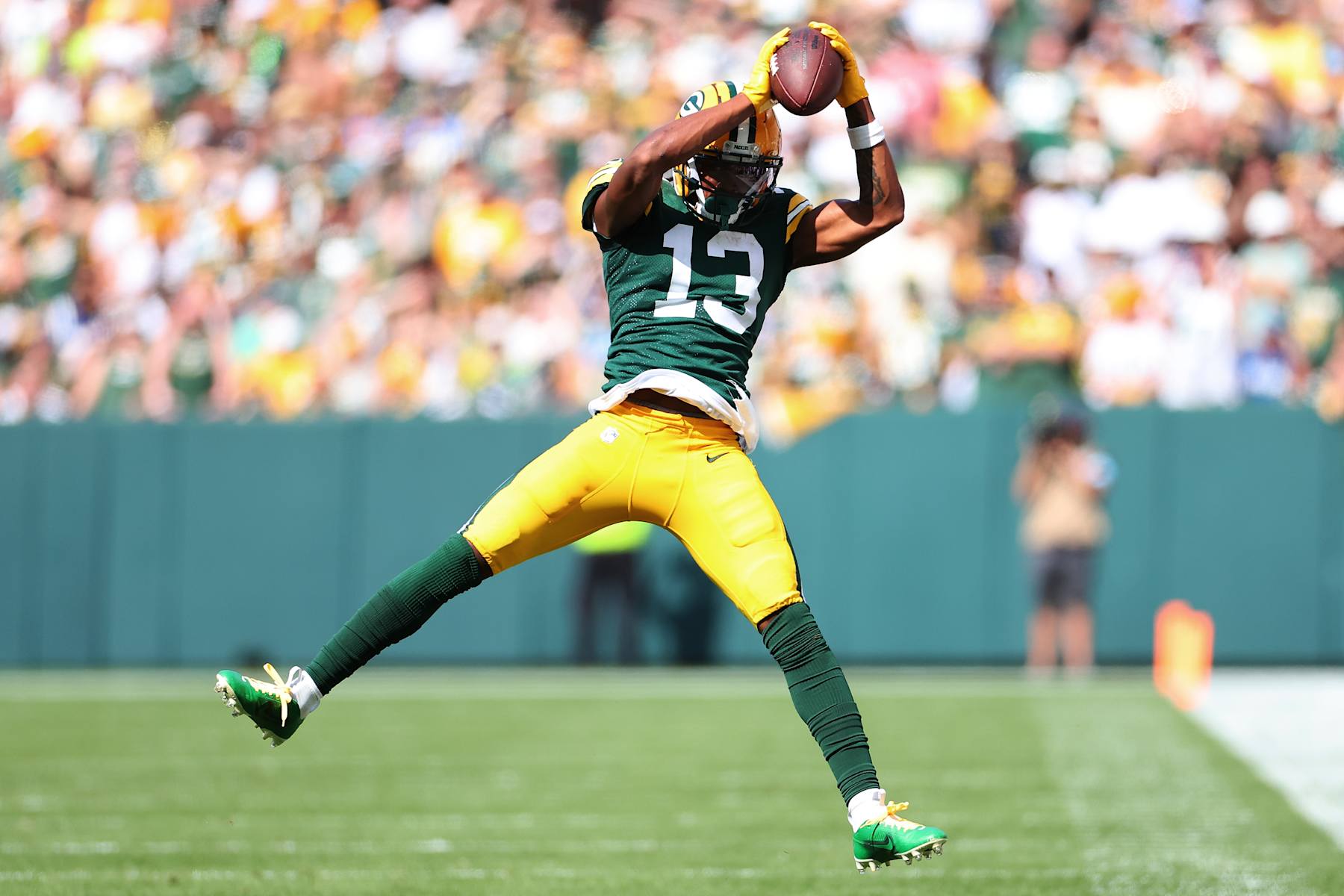 GREEN BAY, WISCONSIN - SEPTEMBER 15: Dontayvion Wicks #13 of the Green Bay Packers catches a pass during a game against the Indianapolis Colts at Lambeau Field on September 15, 2024 in Green Bay, Wisconsin.  The Packers defeated the Colts 16-10. (Photo by Stacy Revere/Getty Images)