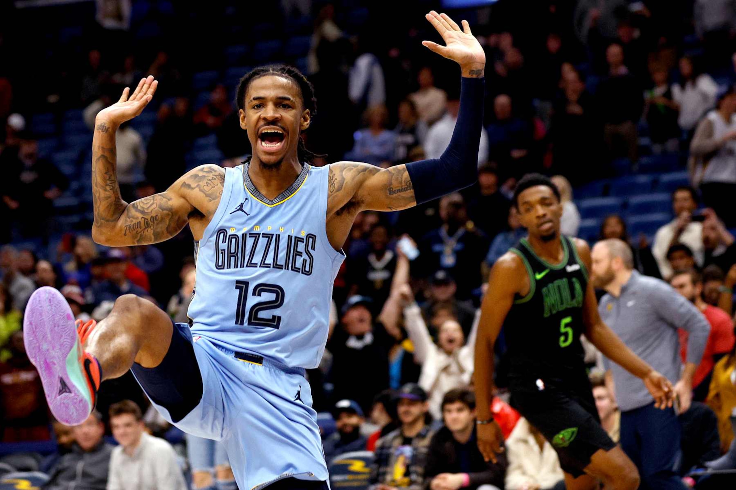NEW ORLEANS, LOUISIANA - DECEMBER 26: Ja Morant #12 of the Memphis Grizzlies reacts after a dunk during overtime of an NBA game against the New Orleans Pelicans at Smoothie King Center on December 26, 2023 in New Orleans, Louisiana. The Memphis Grizzlies won the game 116 - 115 over the New Orleans Pelicans. NOTE TO USER: User expressly acknowledges and agrees that, by downloading and or using this photograph, User is consenting to the terms and conditions of the Getty Images License Agreement. (Photo by Sean Gardner/Getty Images)