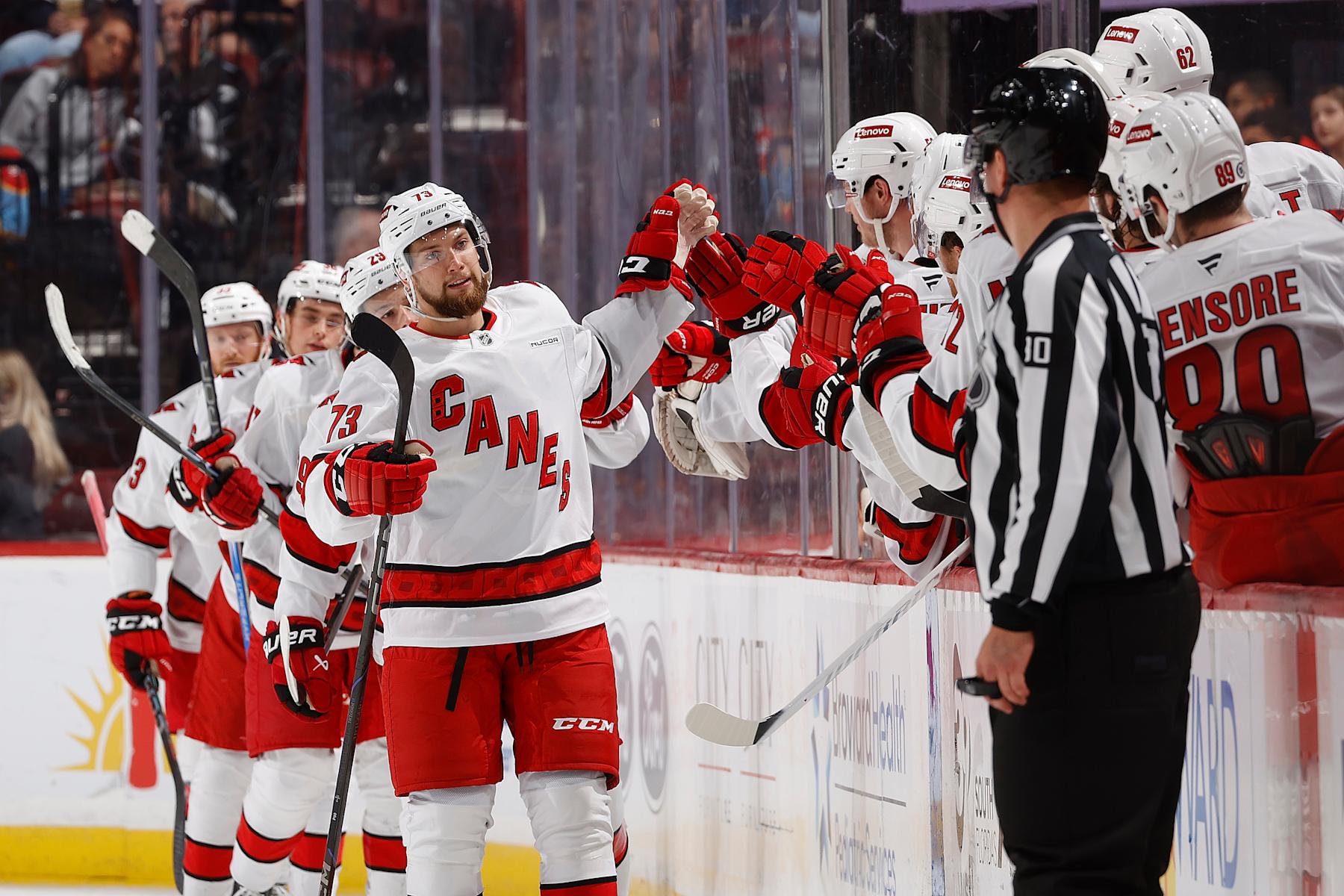 SUNRISE, FL - SEPTEMBER 28:  Gleb Trikozov #73 of the Carolina Hurricanes skates by the team bench to celebrate with teammates after scoring a second period goal against the Florida Panthers during a preseason game at the Amerant Bank Arena on September 28, 2024 in Sunrise, Florida. (Photo by Joel Auerbach/Getty Images)