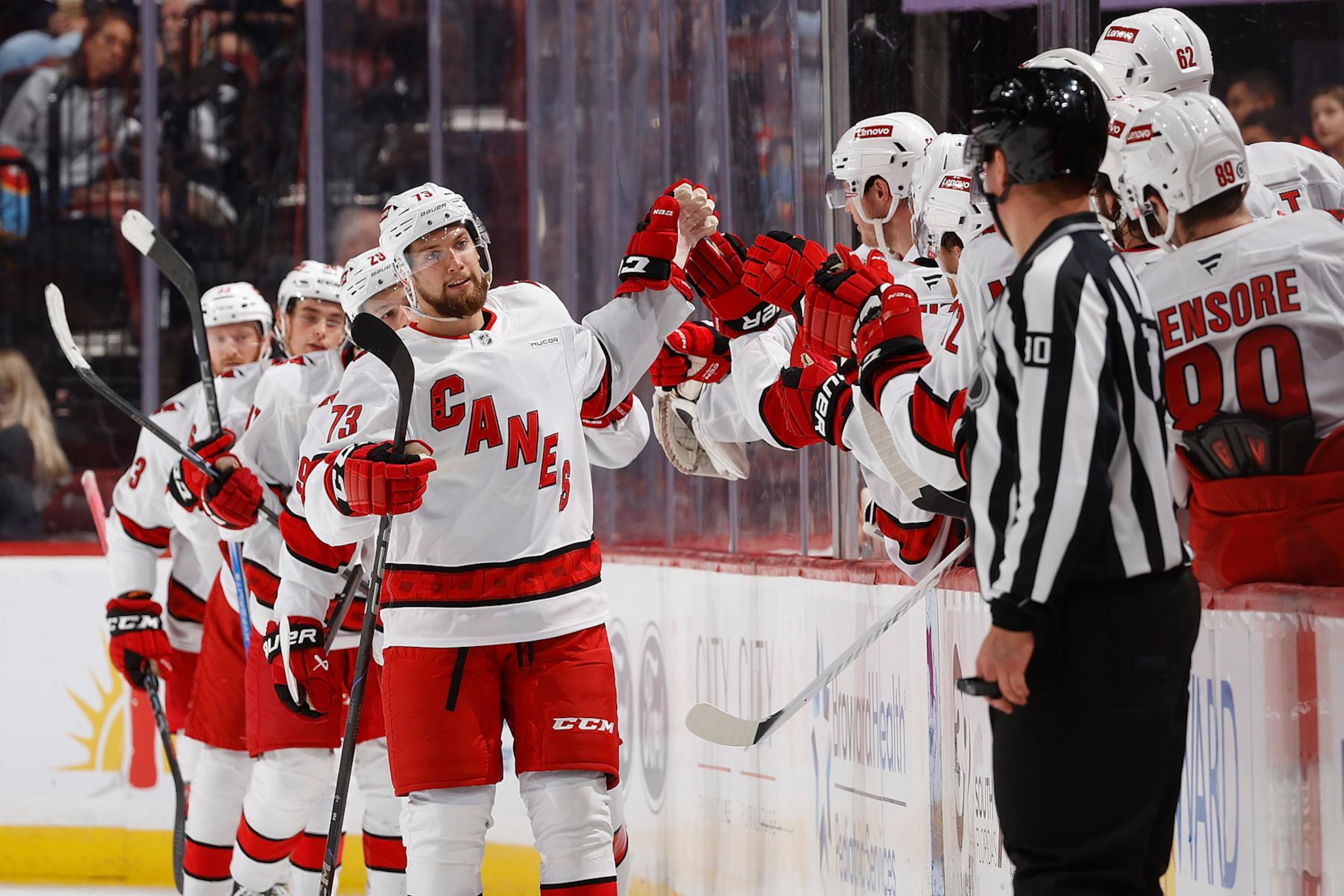 SUNRISE, FL - SEPTEMBER 28:  Gleb Trikozov #73 of the Carolina Hurricanes skates by the team bench to celebrate with teammates after scoring a second period goal against the Florida Panthers during a preseason game at the Amerant Bank Arena on September 28, 2024 in Sunrise, Florida. (Photo by Joel Auerbach/Getty Images)