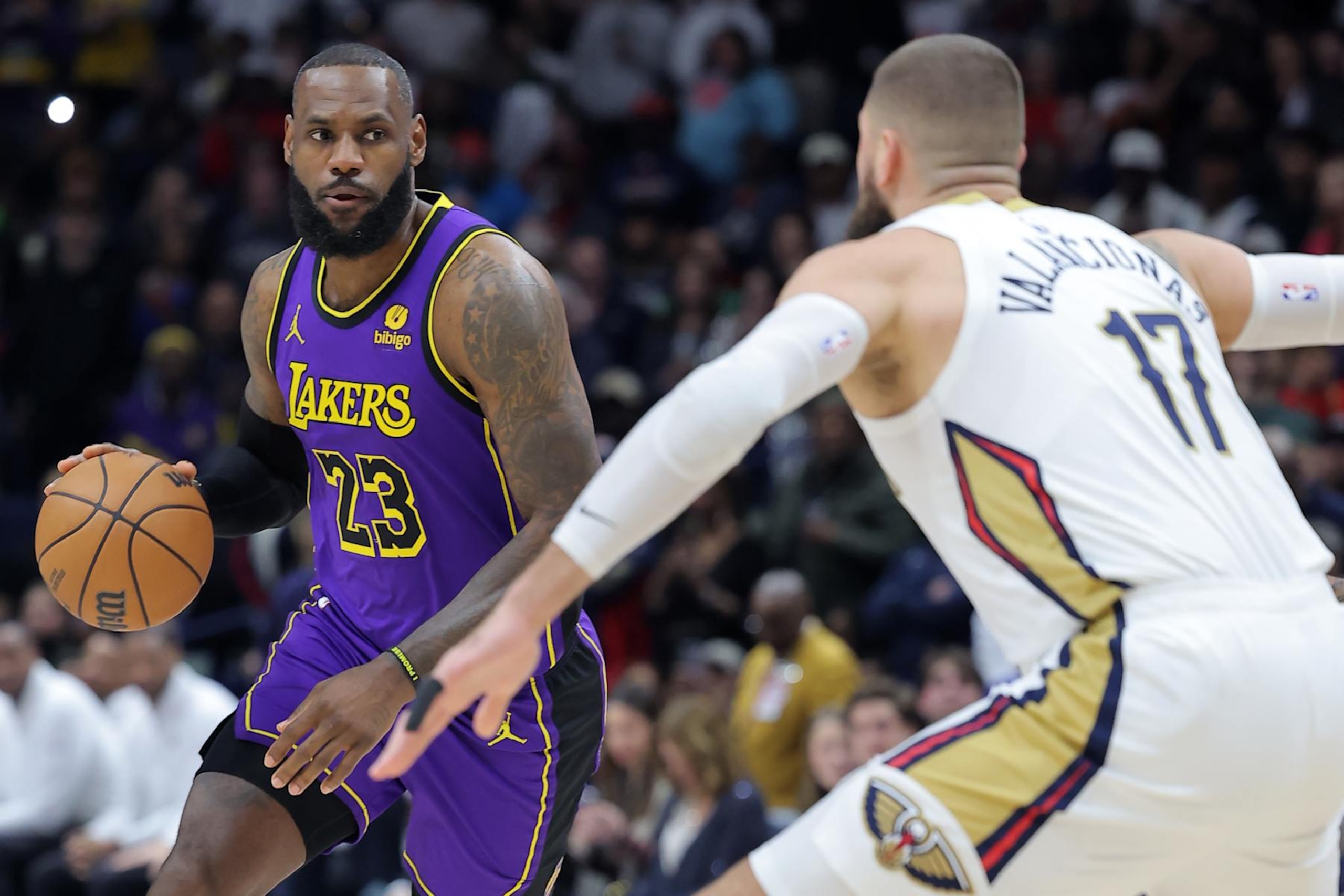 NEW ORLEANS, LOUISIANA - DECEMBER 31: LeBron James #23 of the Los Angeles Lakers drives against Jonas Valanciunas #17 of the New Orleans Pelicans during the first half at the Smoothie King Center on December 31, 2023 in New Orleans, Louisiana. NOTE TO USER: User expressly acknowledges and agrees that, by downloading and or using this Photograph, user is consenting to the terms and conditions of the Getty Images License Agreement. (Photo by Jonathan Bachman/Getty Images)
