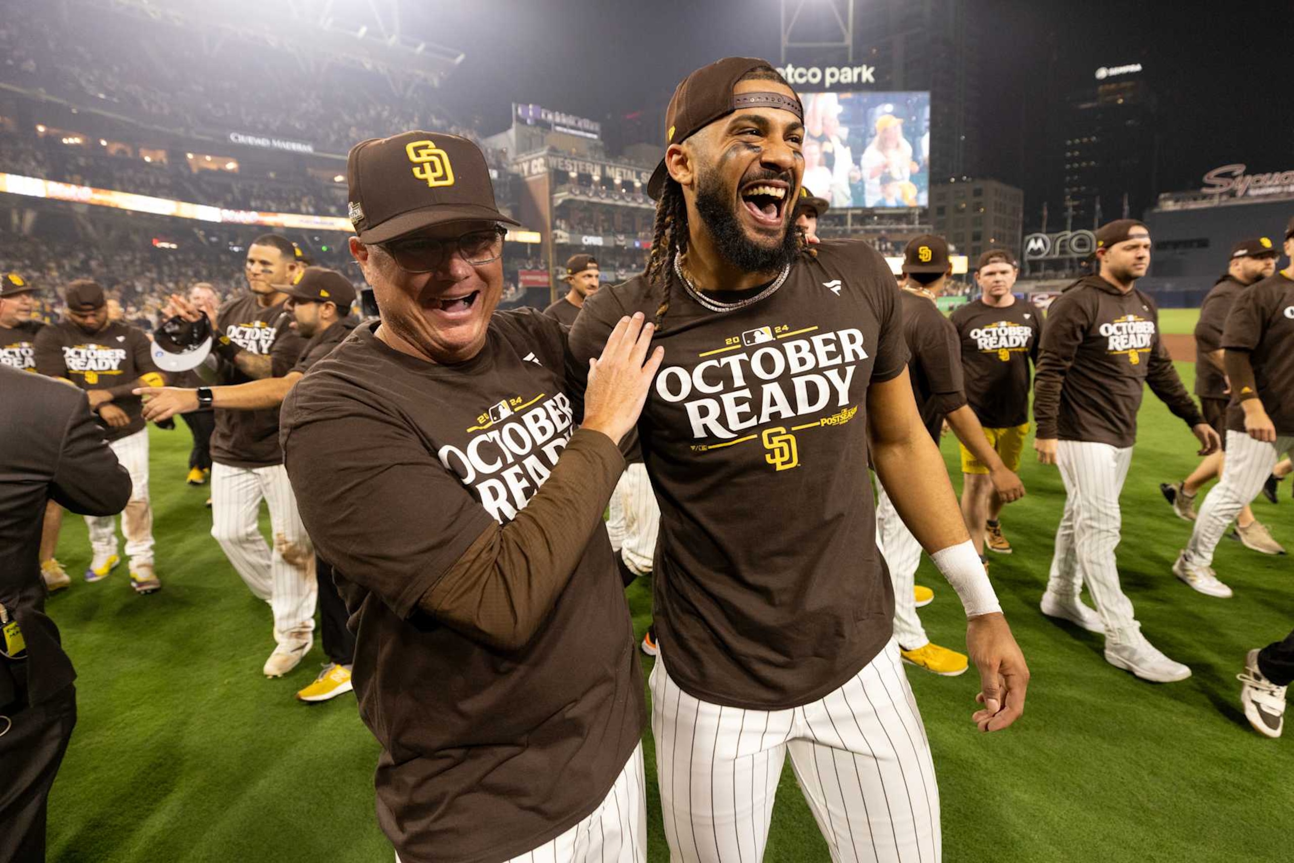 SAN DIEGO, CALIFORNIA - OCTOBER 02: Manager Mike Shildt hugs Fernando Tatis Jr. #23 of the San Diego Padres walks  after defeating the Atlanta Braves 5-4 to advance to the NL Division Series against the Los Angeles Dodgers  at Petco Park on October 02, 2024 in San Diego, California. (Photo by Sean M. Haffey/Getty Images)