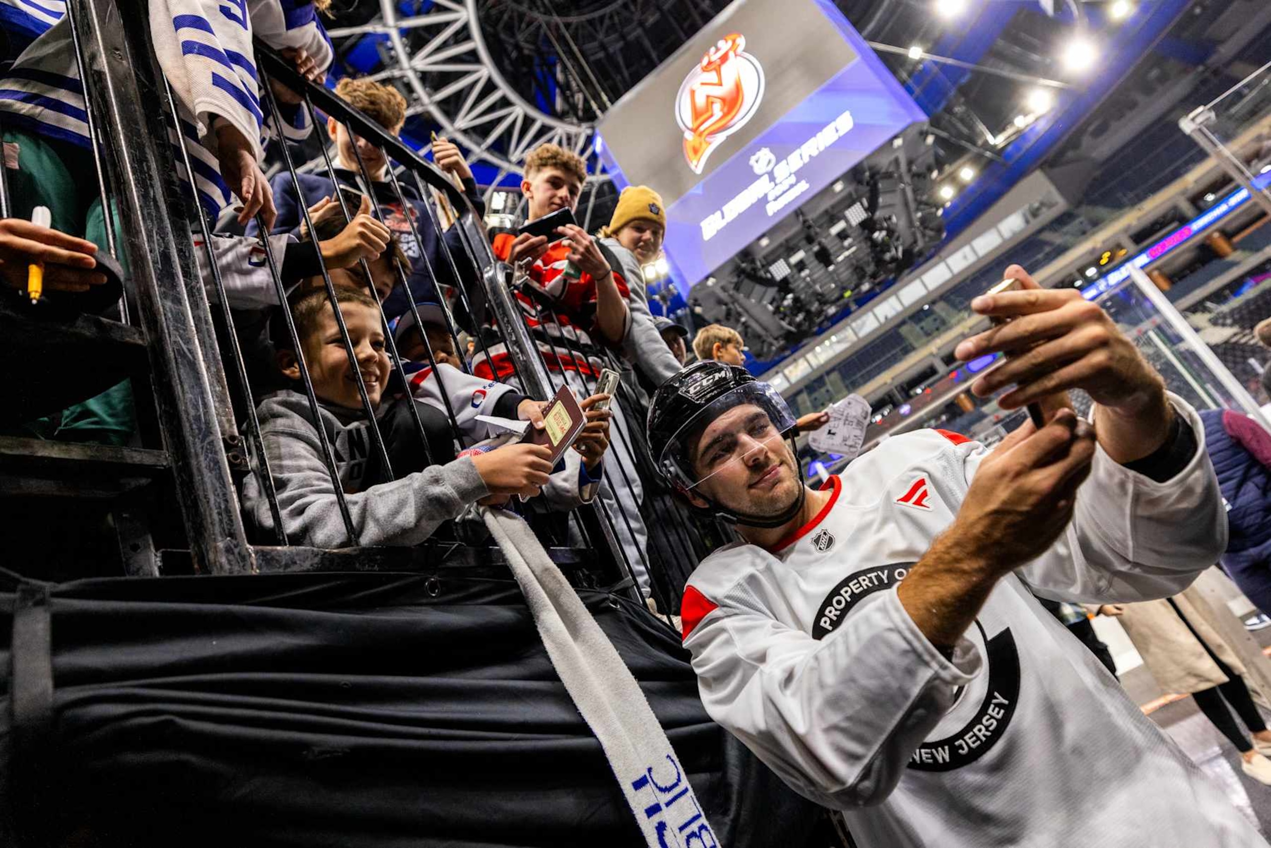PRAGUE, CZECH REPUBLIC - OCTOBER 3: Nico Hischier #13 of the New Jersey Devils takes a photo with fans after practice prior to the 2024 NHL Global Series Challenge at O2 Arena on October 3, 2024 in Prague, Czech Republic. (Photo by Andrew Maclean/NHLI via Getty Images)