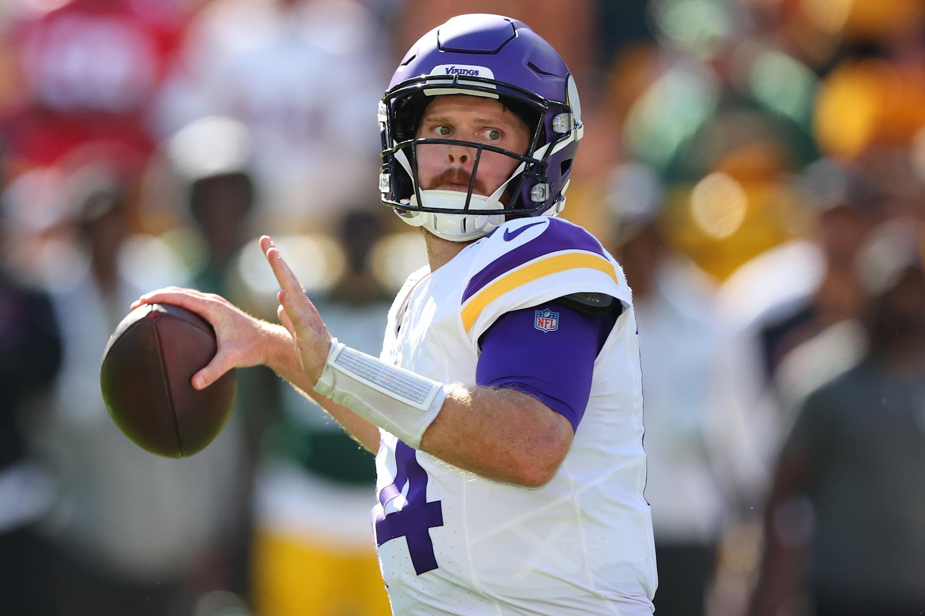 GREEN BAY, WISCONSIN - SEPTEMBER 29: Sam Darnold #14 of the Minnesota Vikings drops back to pass during a game against the Green Bay Packers at Lambeau Field on September 29, 2024 in Green Bay, Wisconsin. (Photo by Stacy Revere/Getty Images)