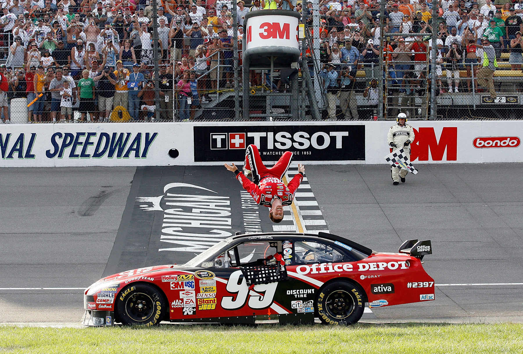 BROOKLYN, MI - AUGUST 17:  Carl Edwards, driver of the #99 Office Depot Ford, celebrates with a backflip from his car after winning the NASCAR Sprint Cup Series 3M Performance 400 at Michigan International Speedway on August 17, 2008 in Brooklyn, Michigan.  (Photo by Geoff Burke/Getty Images for NASCAR)