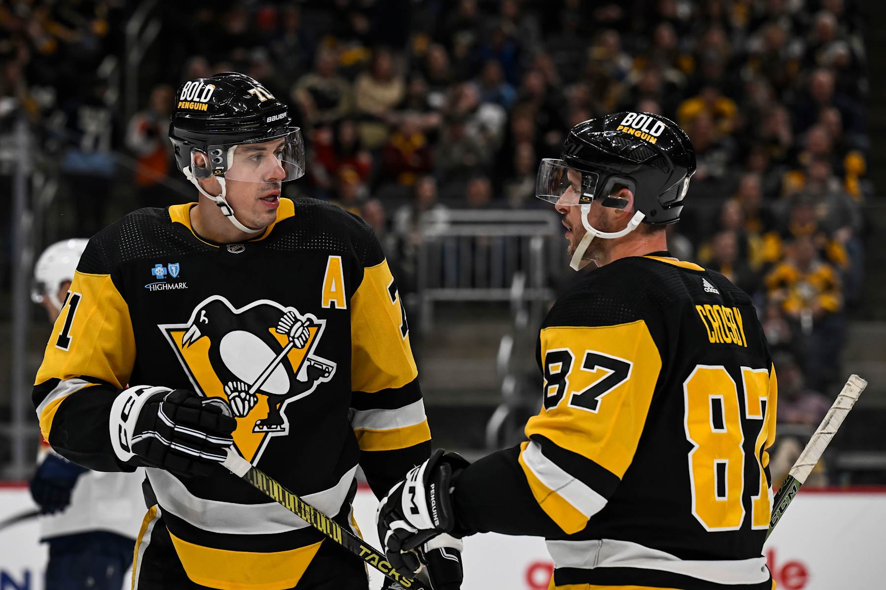 PITTSBURGH, PA - JANUARY 26: Pittsburgh Penguins center Evgeni Malkin (71) and Pittsburgh Penguins center Sidney Crosby (87) talk during the second period in the NHL game between the Pittsburgh Penguins and the Florida Panthers on January 26, 2024, at PPG Paints Arena in Pittsburgh, PA. (Photo by Jeanine Leech/Icon Sportswire via Getty Images)